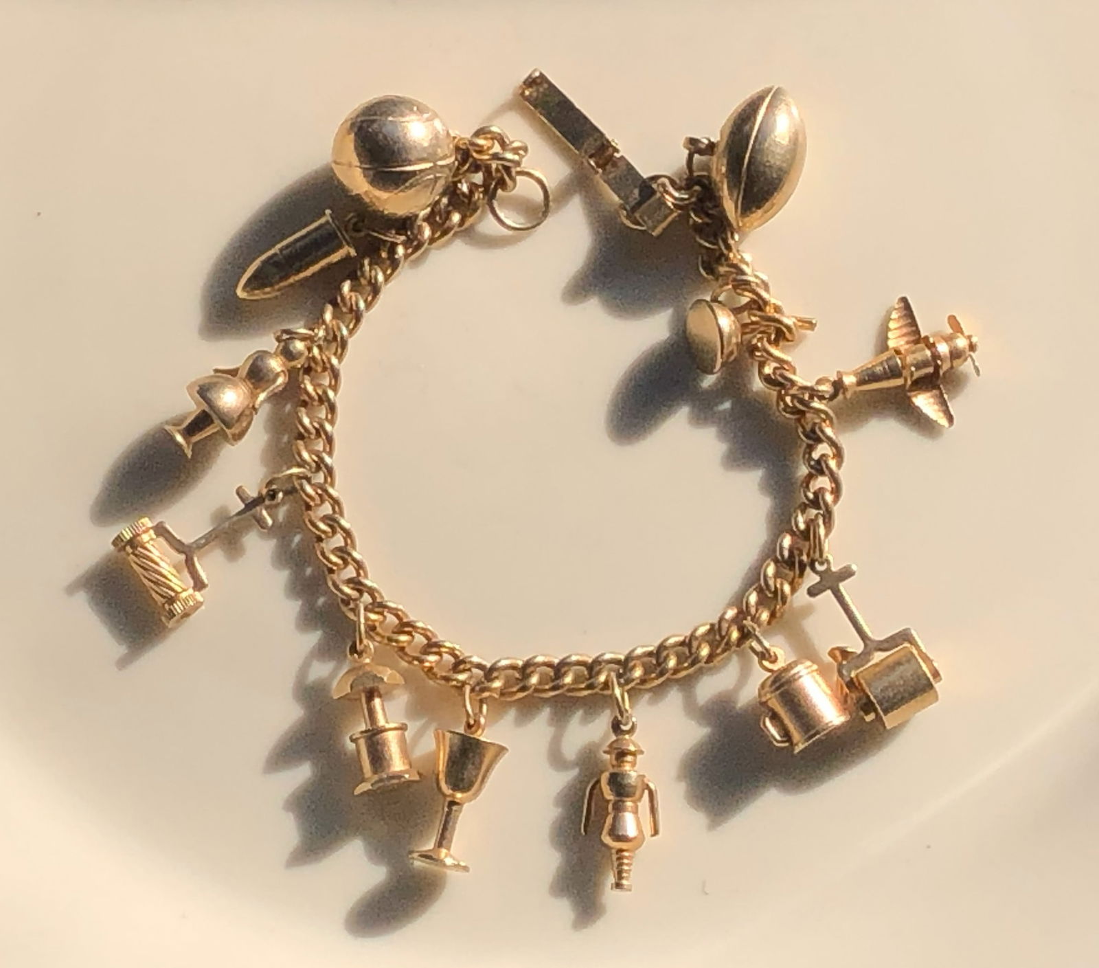Gold Color Charm Bracelet: A beautiful gold color charm bracelet with various unique charms.