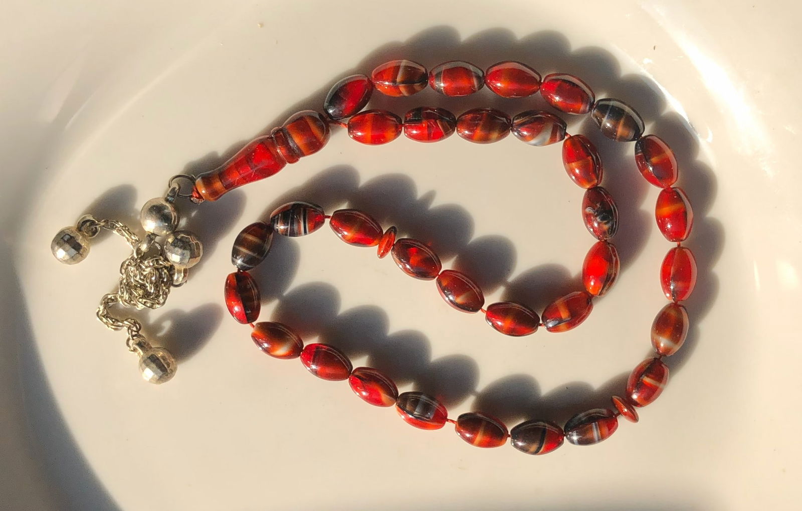 Red Beaded Necklace: A beautiful red beaded necklace with intricate design.