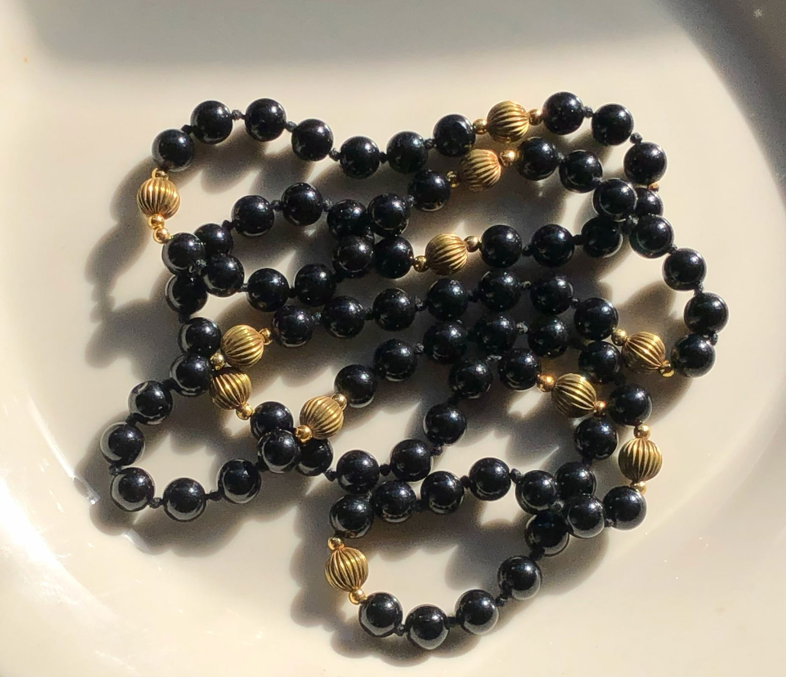 Black and Gold Color Beaded Necklace: Elegant black beads with gold color accents, perfect for any occasion.