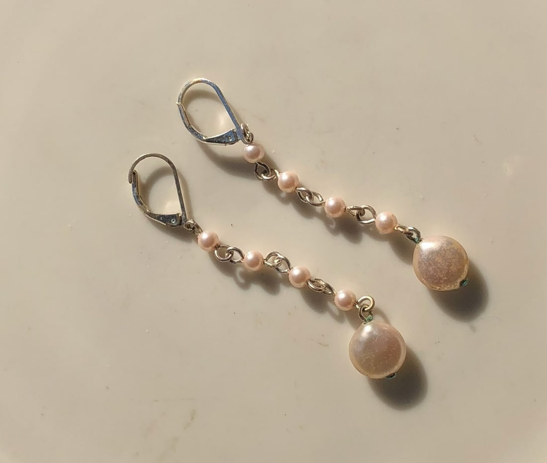 Pearl Drop Earrings: Elegant pearl drop earrings with a delicate chain design.