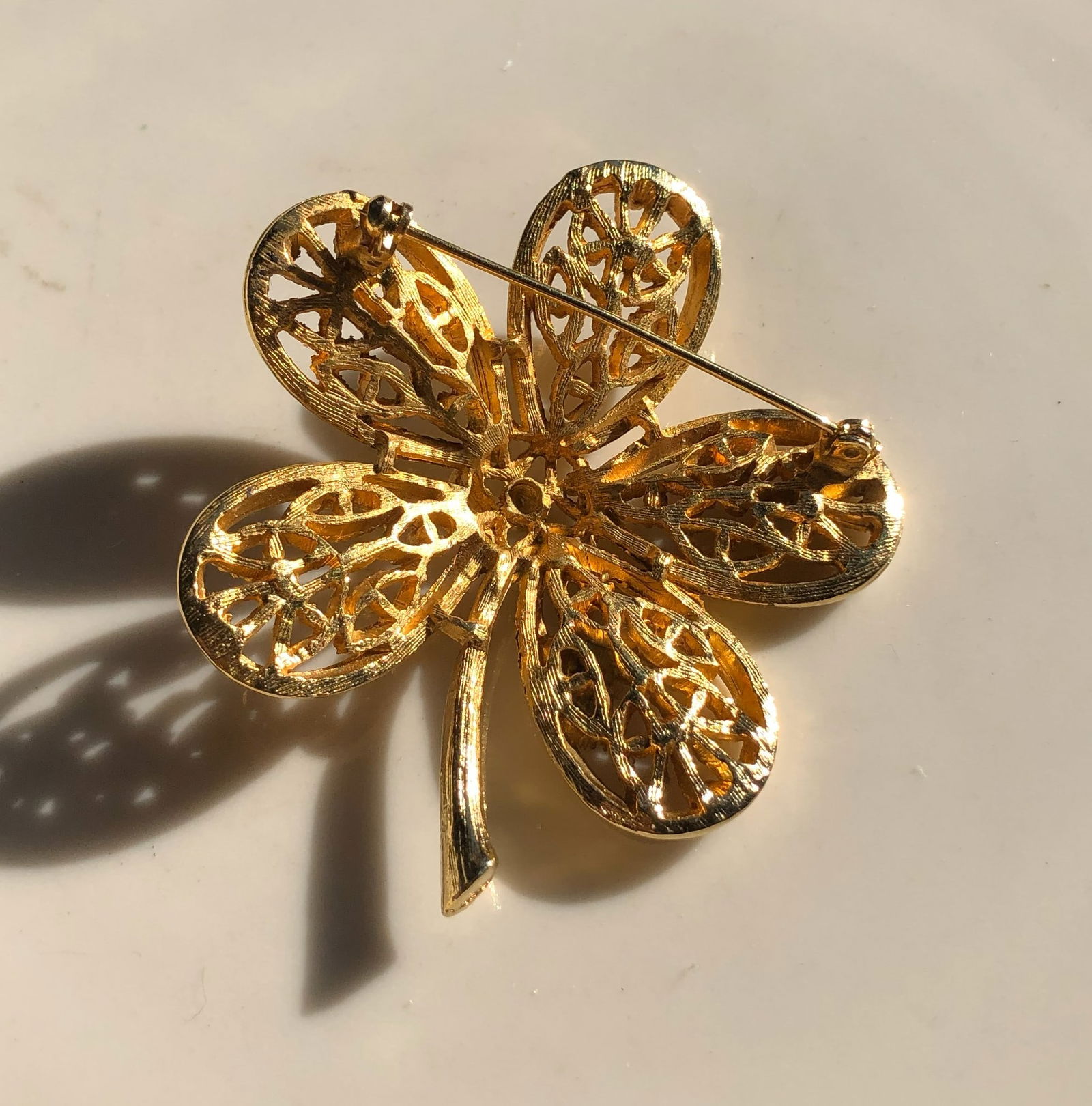 Gold Filled Filigree Flower Brooch: A beautifully crafted gold filled filigree brooch in the shape of a flower.