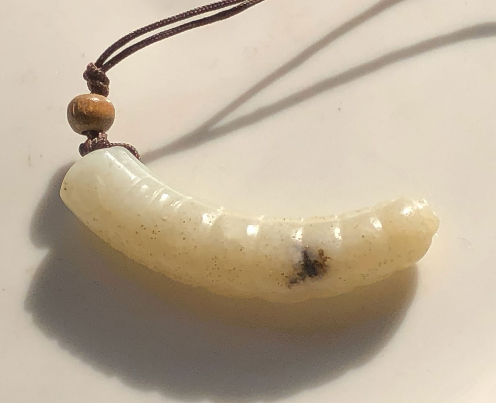 Antique Jade Pendant Necklace: Antique beautiful jade pendant necklace with a wooden bead accent. Size: 2".