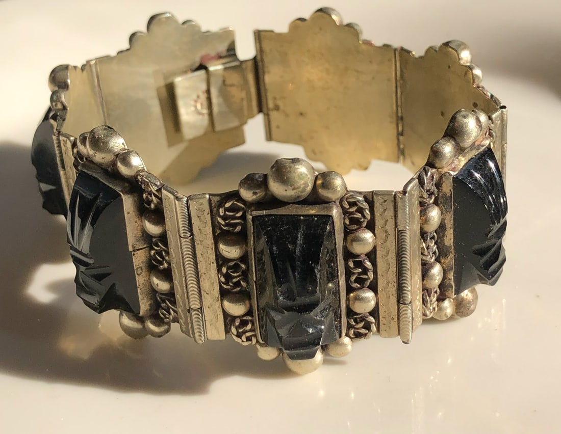 Vintage Silver Bracelet: A beautifully crafted vintage silver bracelet with intricate designs and black stone accents. Weight 64g.
