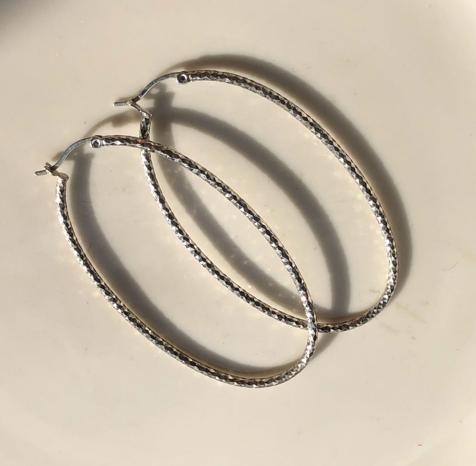 Silver Hoop Earrings: Elegant silver hoop earrings with a textured design.