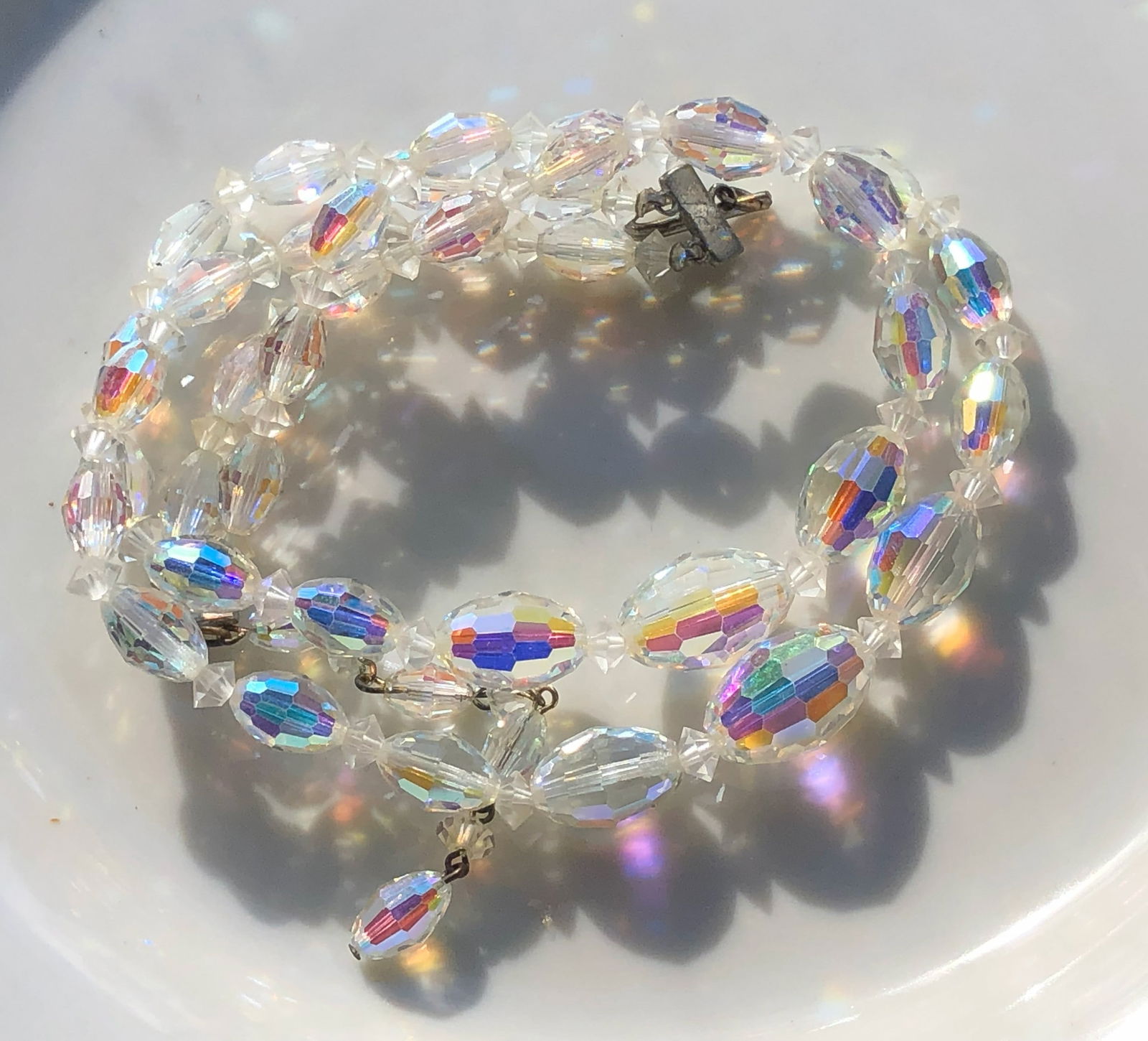 Iridescent Beaded Necklace: A beautiful iridescent beaded necklace that shimmers in the light.