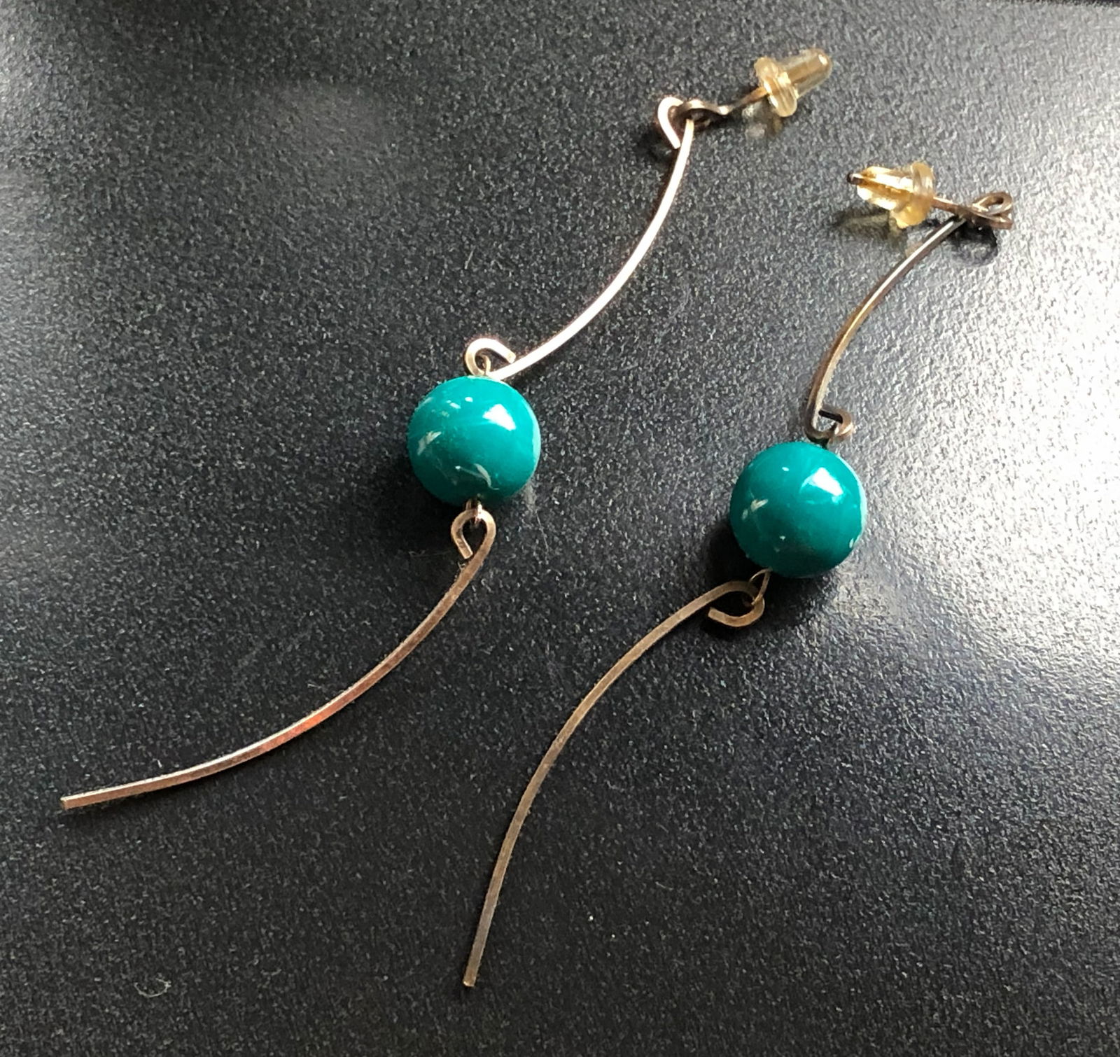 Vintage Bead Earrings: Elegant earrings featuring beads and a unique curved design.