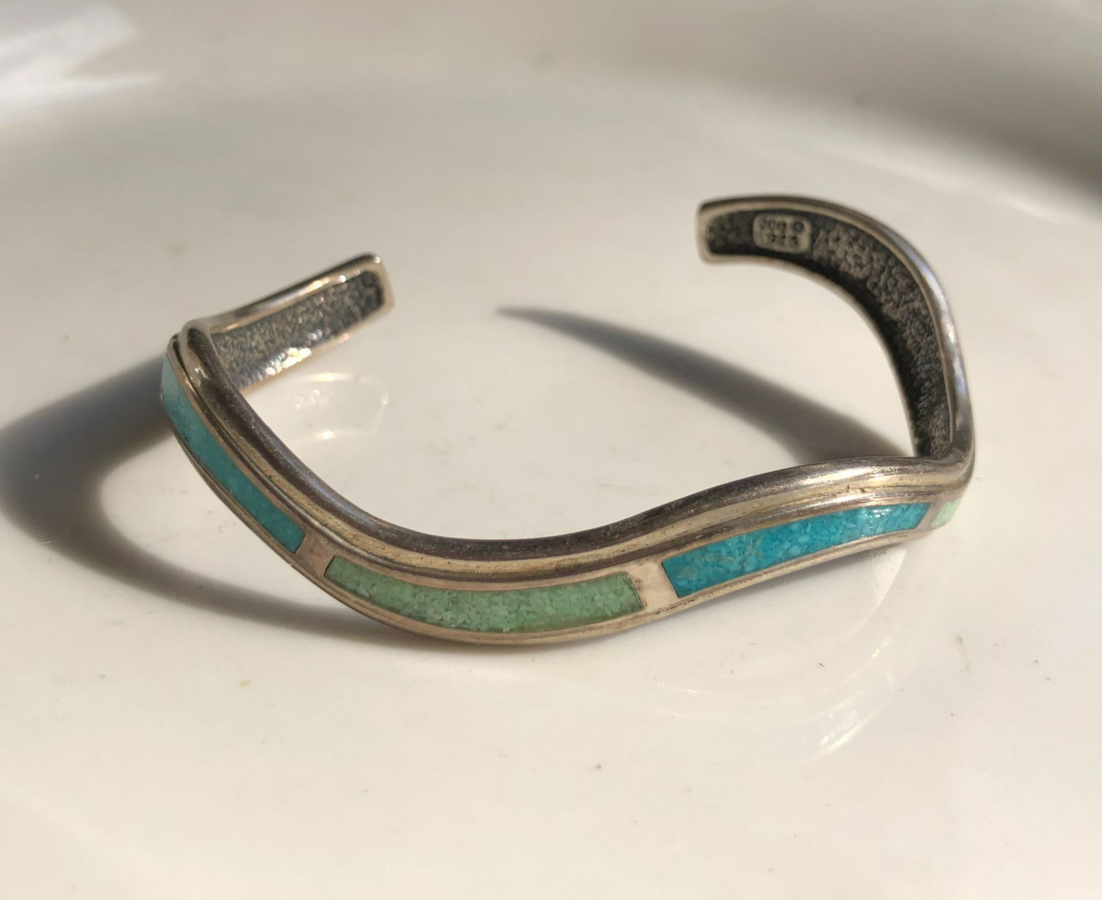 Turquoise Coo Inlay Silver Bracelet: A handcrafted Siver bracelet featuring turquoise inlay with a unique wave design. Weight 21g