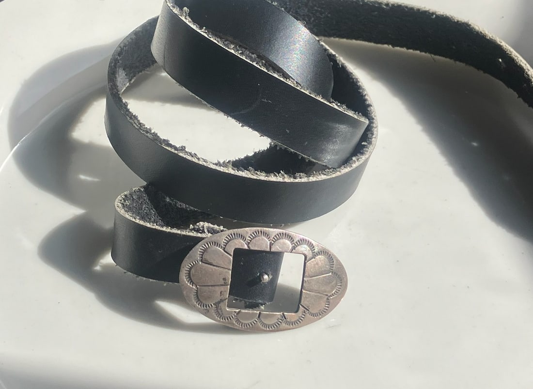 Leather Belt with Silver Buckle: A stylish leather belt featuring a decorative silver buckle.