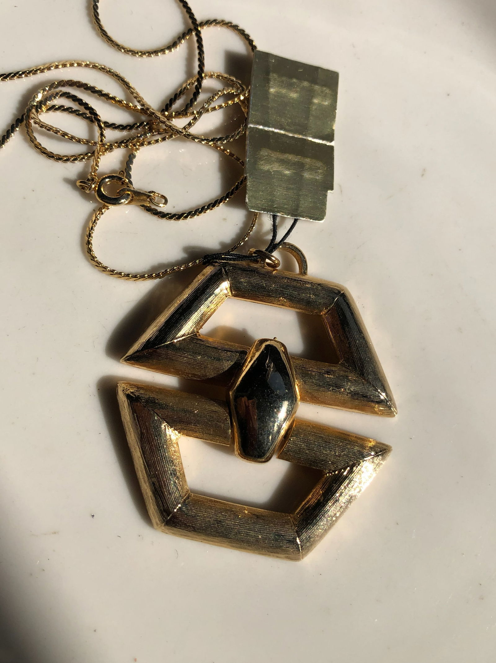 Gold Color Pendant Necklace: Elegant gold color pendant necklace with a unique geometric design.