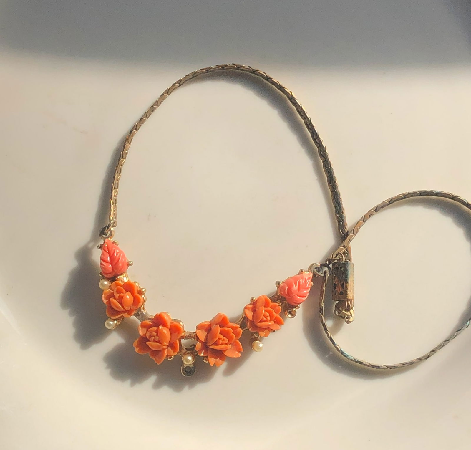 Floral Necklace: A beautiful floral necklace with orange flowers and pearl accents.