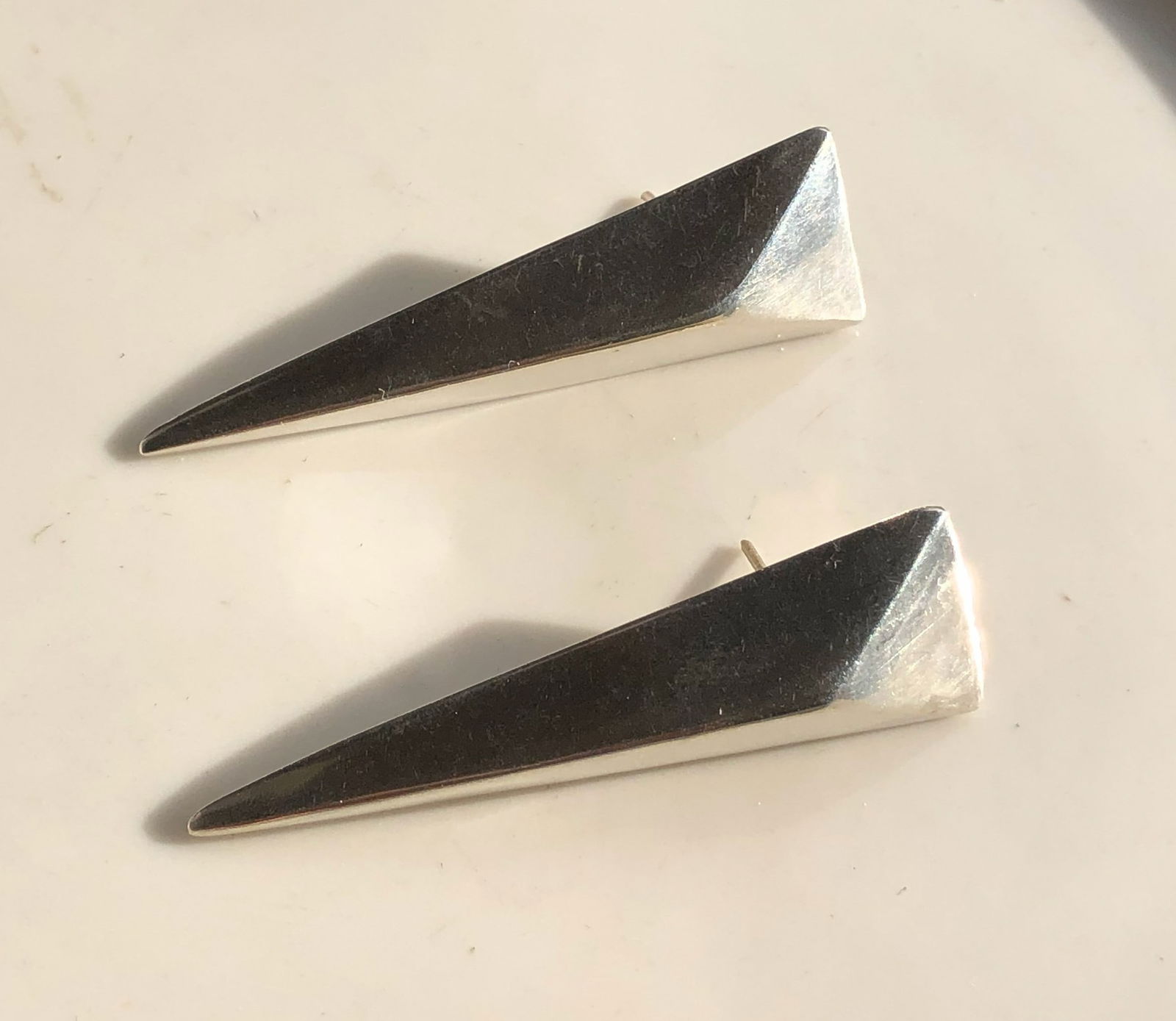 Silver Geometric Earrings: Elegant silver geometric earrings with a modern design. Size: 2.5"