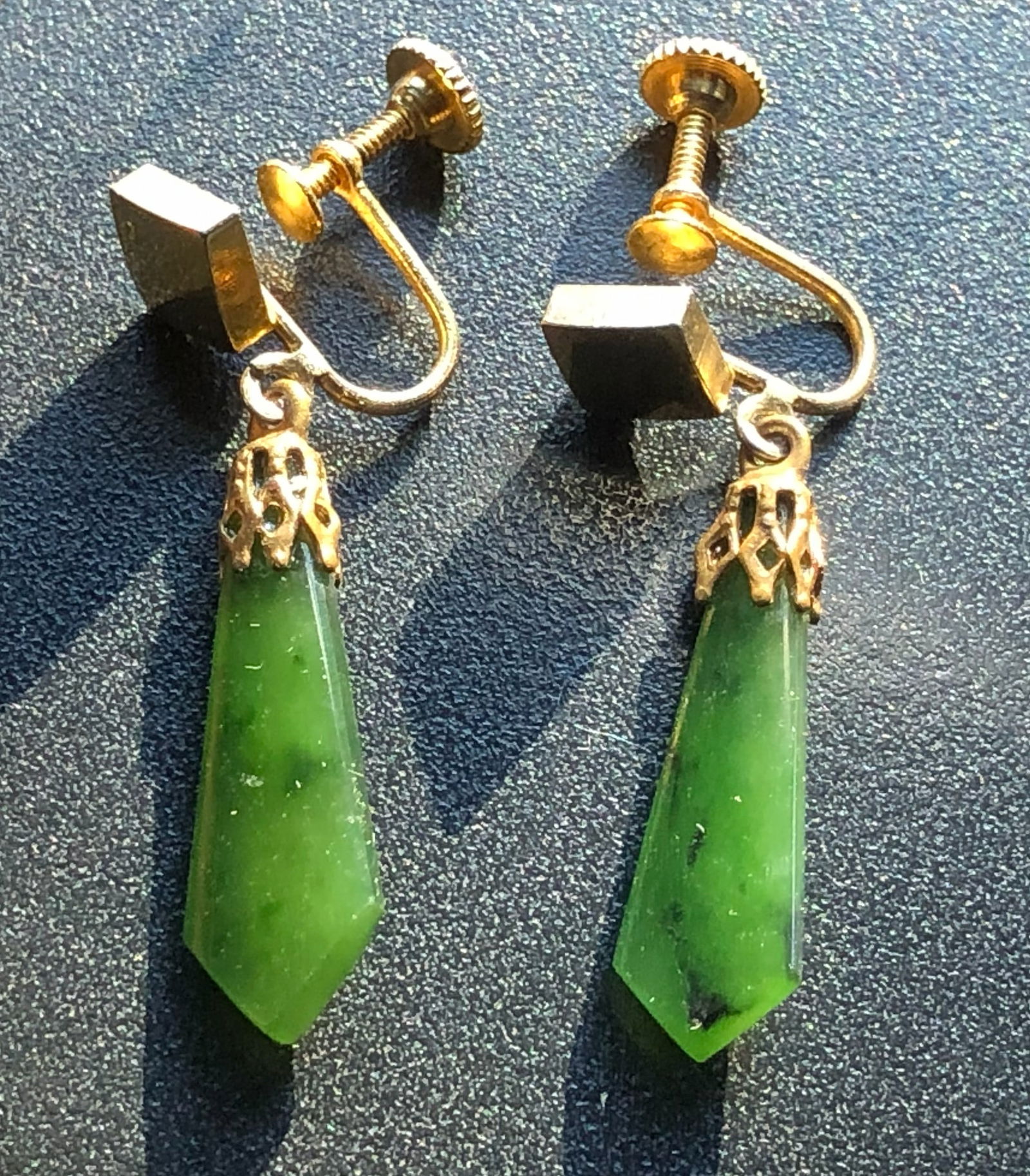Green Jade Earrings: Elegant green Jade earrings with gold-tone screw backings.
