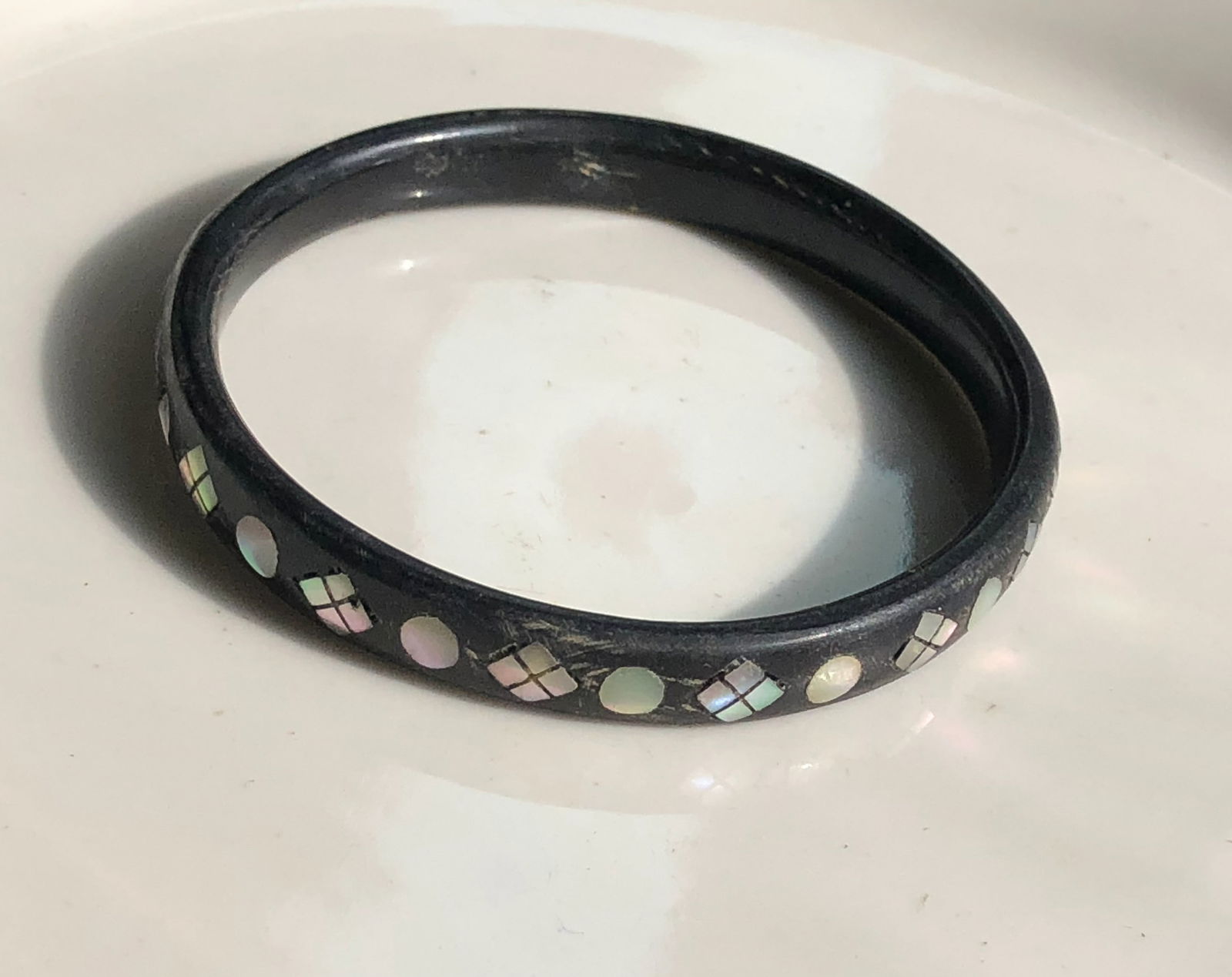 Black Bangle with Inlay: A stylish black bangle featuring a unique inlay design.