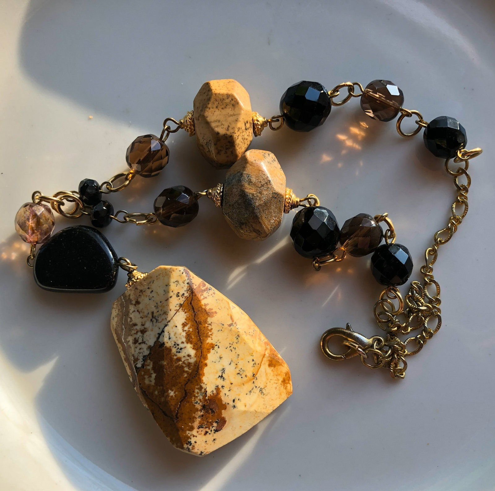 Handcrafted Stone Necklace: A unique handcrafted necklace featuring natural stones and beads.