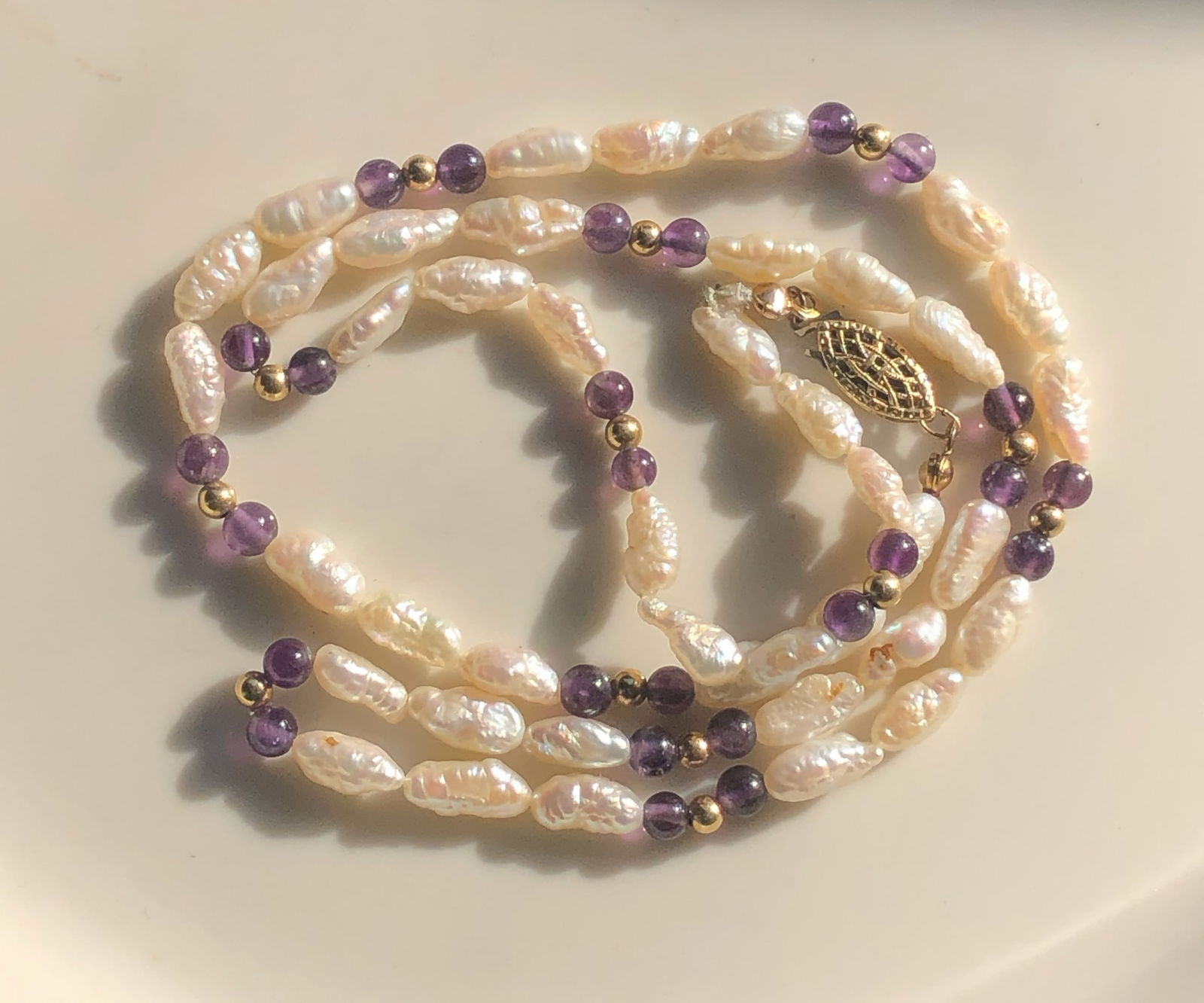 Pearl and Amethyst Necklace: Elegant necklace featuring freshwater pearls and amethyst beads.
