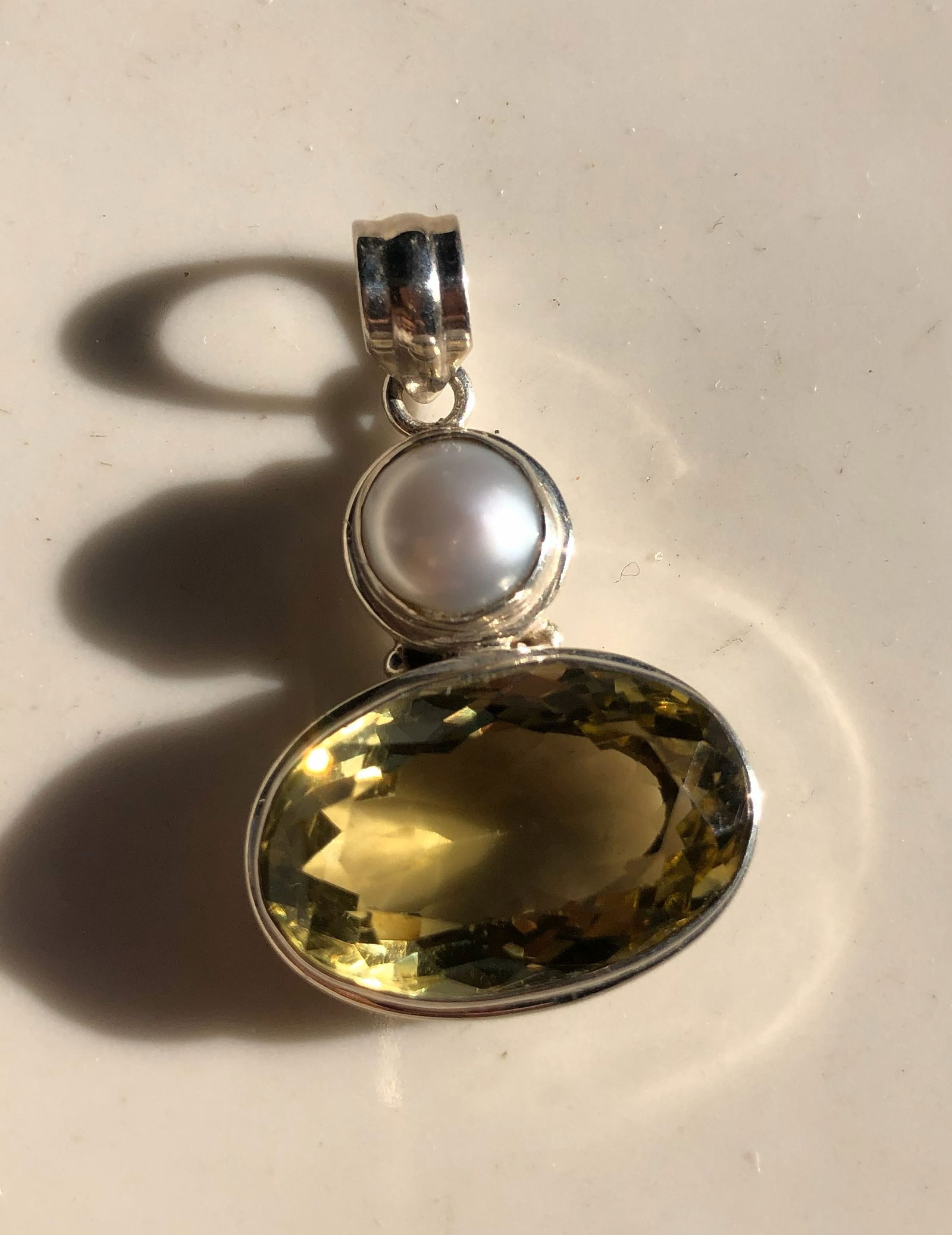 Pearl and Citrine Silver Pendant: Elegant pendant featuring a pearl and citrine gemstone set in silver. Size: 1.75", weight: 17g.