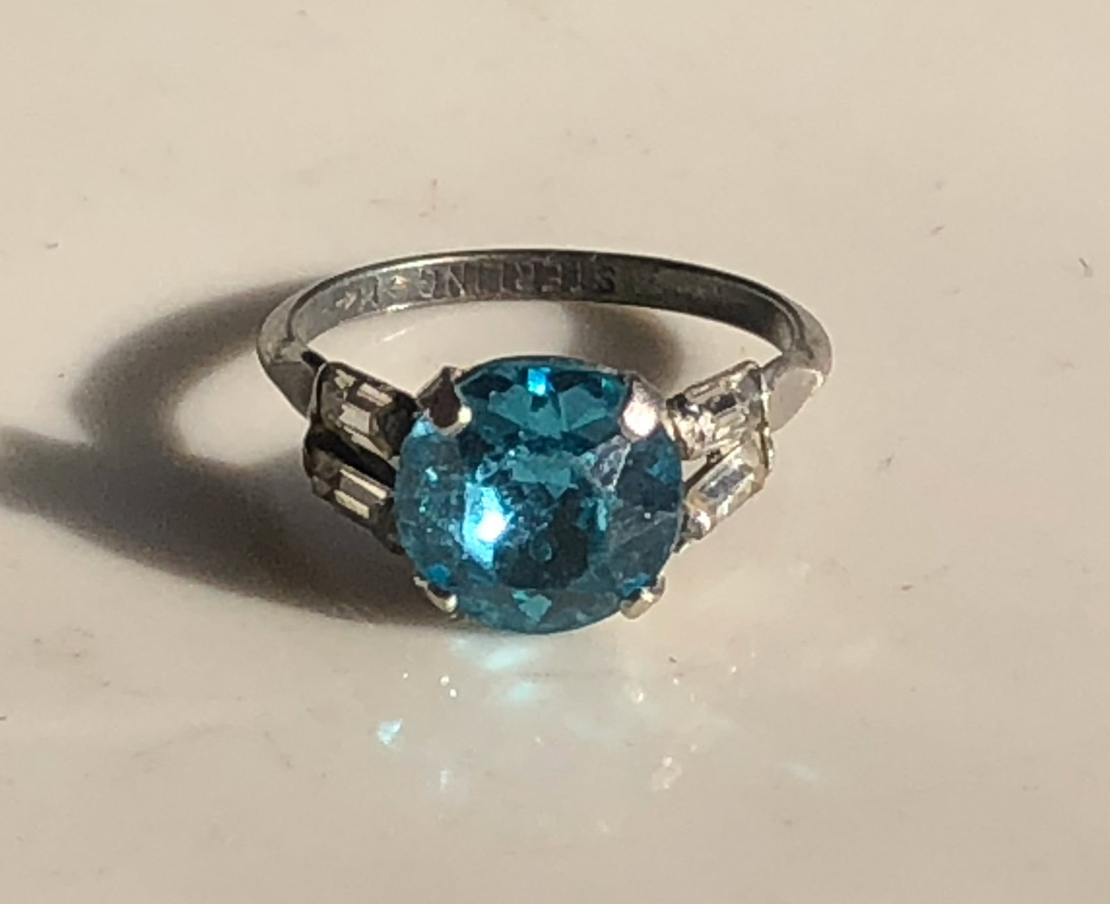 Blue Gemstone Silver Ring: A stunning blue gemstone ring with a silver band. Size 5.