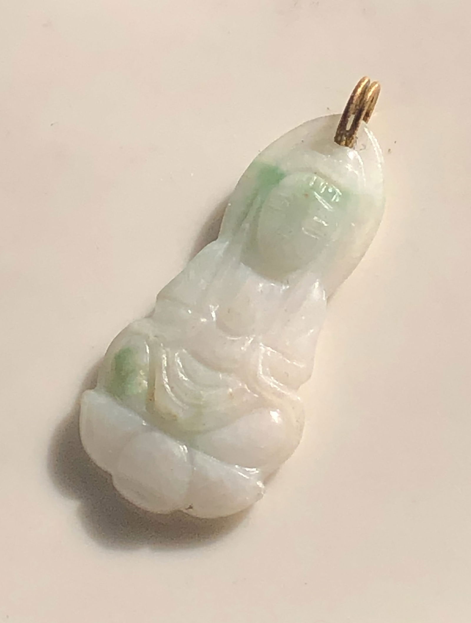 Jadeite Pendant: A beautiful jadeite pendant with intricate carvings. Size: 1.5".