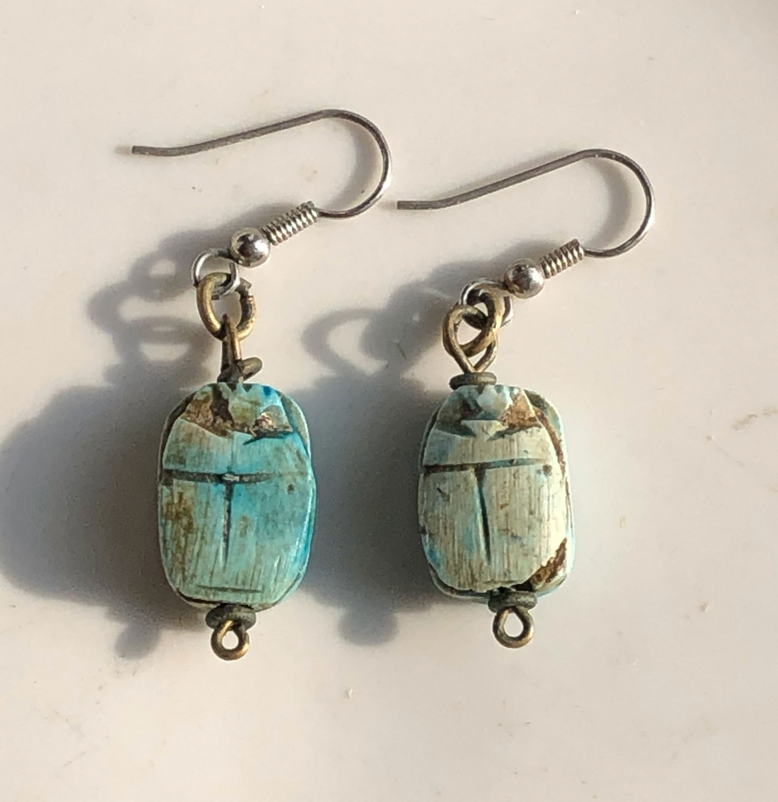 Turquoise Scarab Earrings: Handcrafted turquoise scarab earrings with hook fastening.