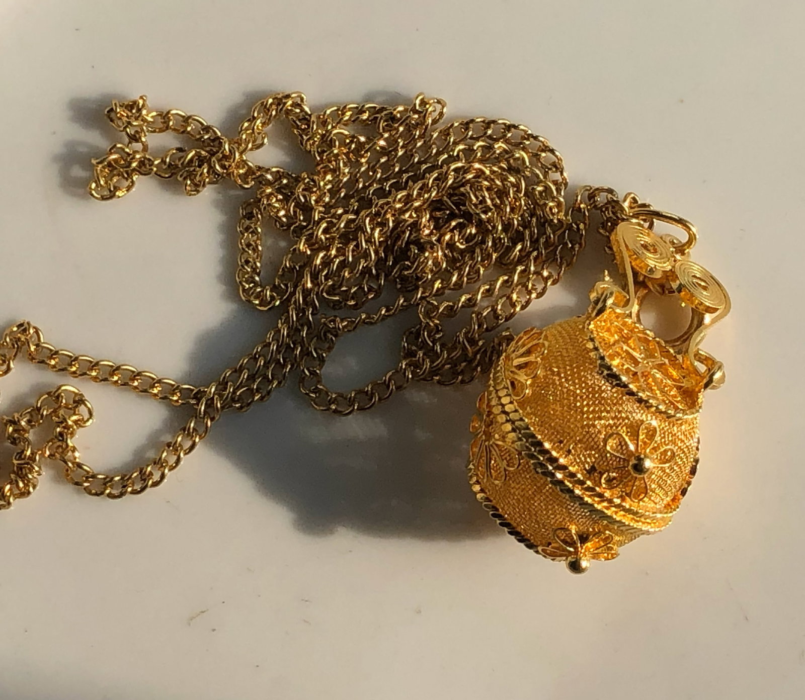 Gold filled Pendant Necklace: Elegant gold filled pendant necklace with intricate floral designs.