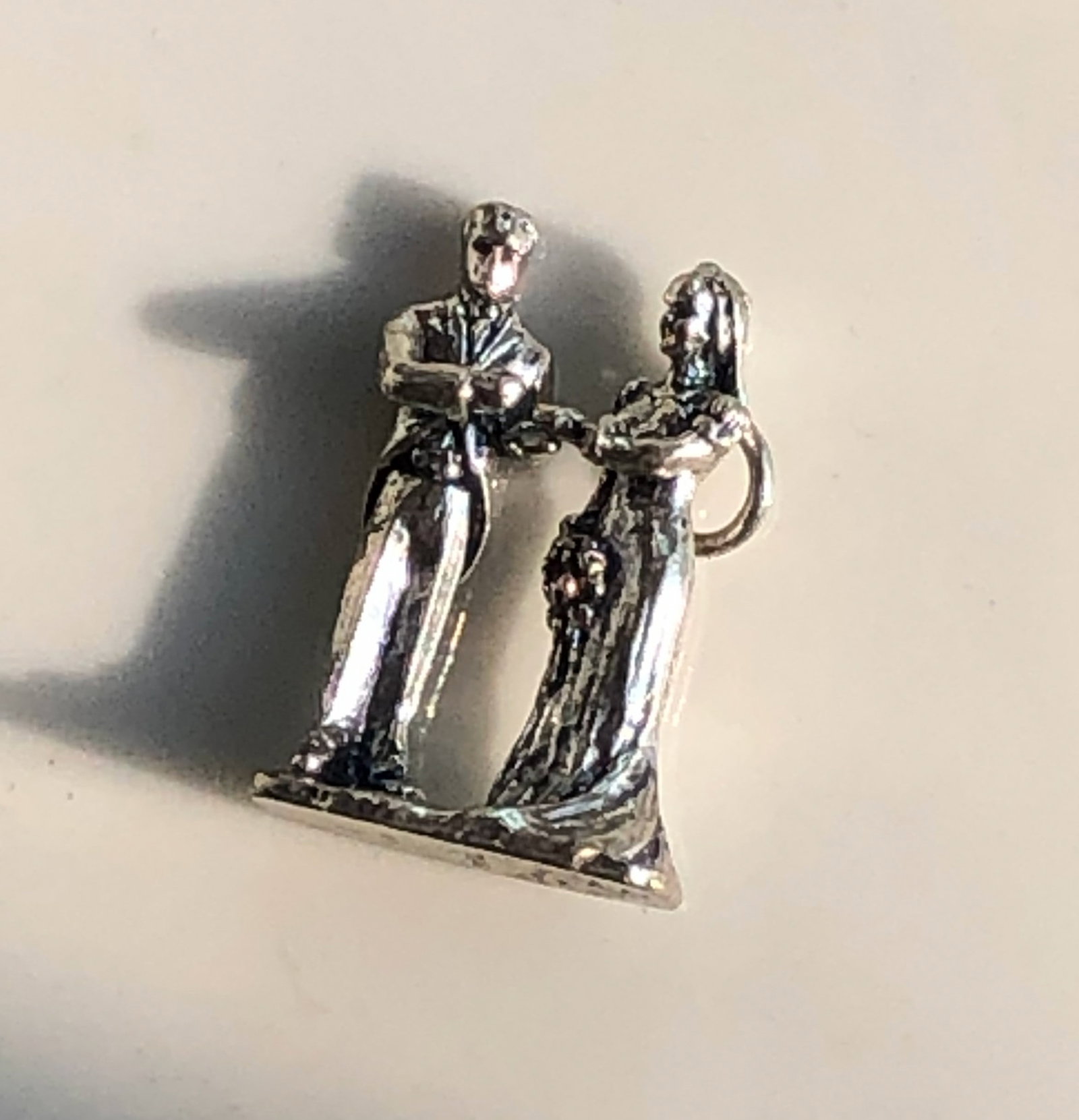 Vintage Silver Figurine: A unique vintage figurine with intricate details and a charming design. Size: 1"