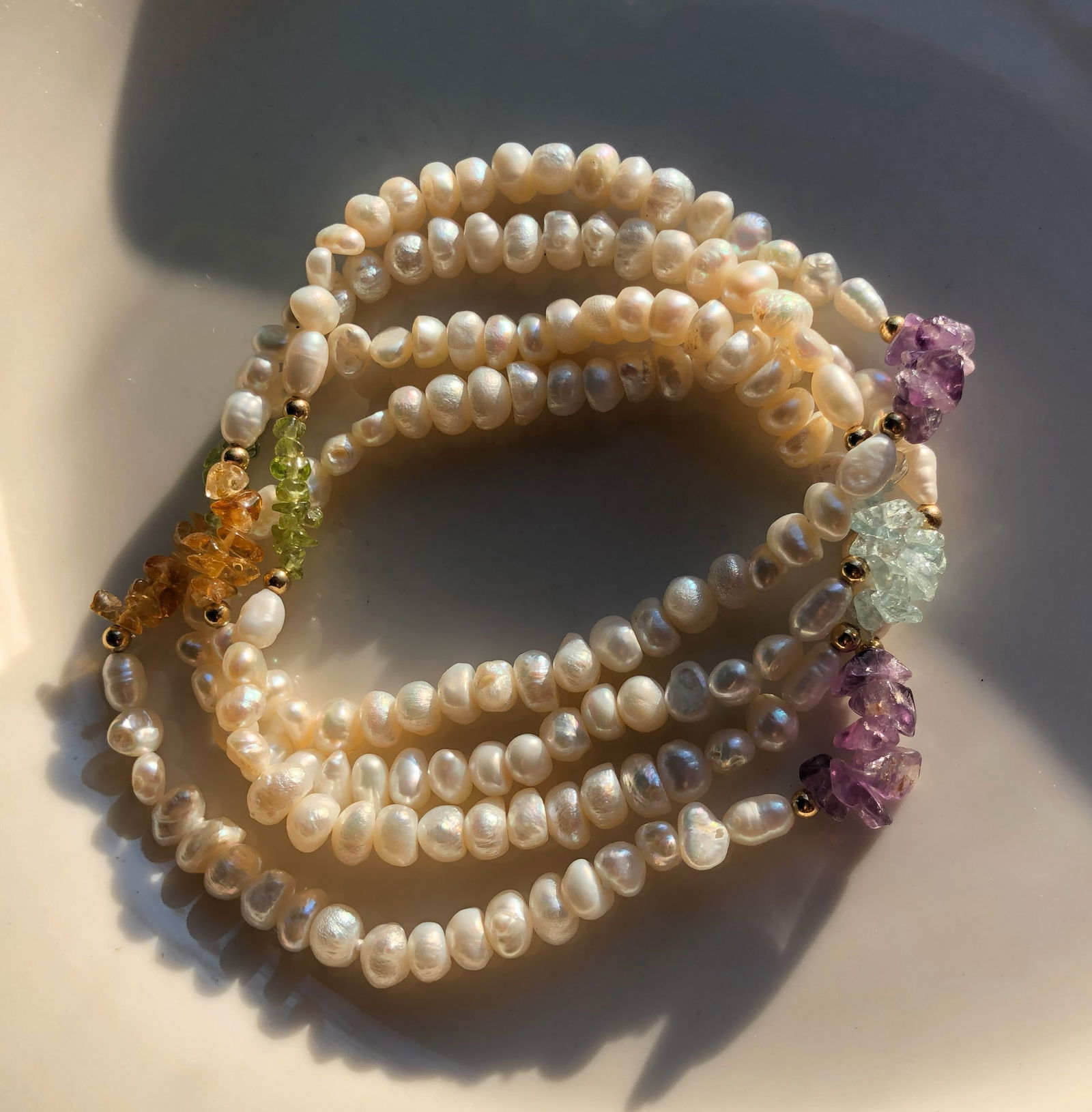 Vintage Pearl Necklace: Elegant pearl Necklace with colorful gemstone accents.