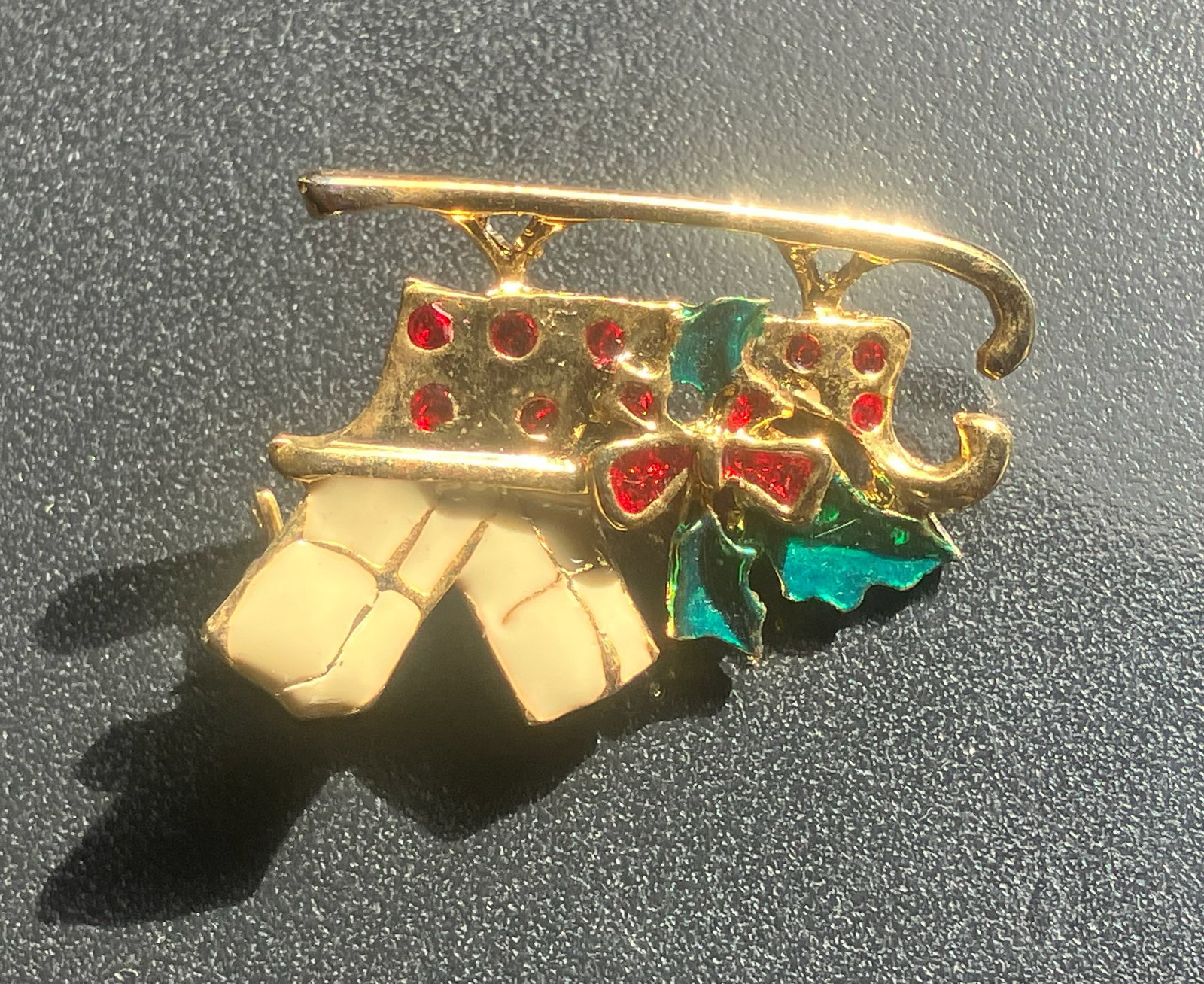 Festive Brooch: A decorative festive brooch with red and green accents.