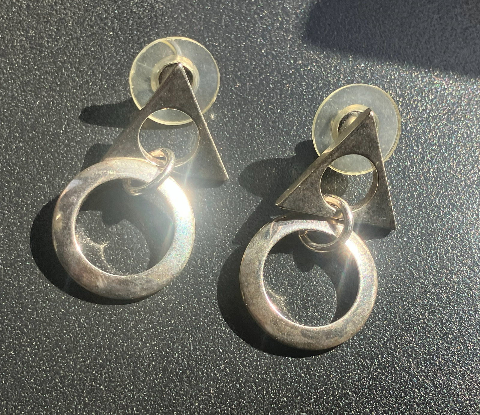 Geometric Silver Earrings: Stylish geometric silver earrings with a triangle and circle design.