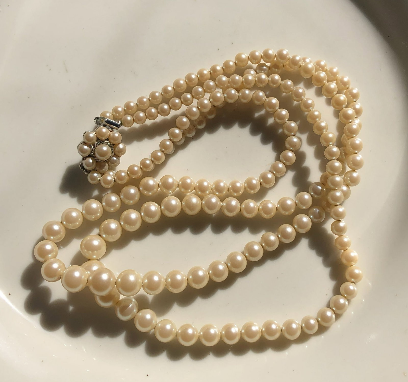 Faux Pearl Necklace: Elegant faux pearl necklace with a classic design.