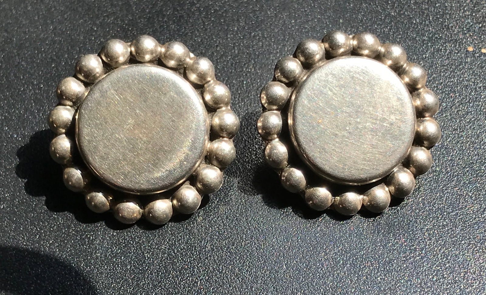 pair of silver round earings with edge decorations (1 of 5)