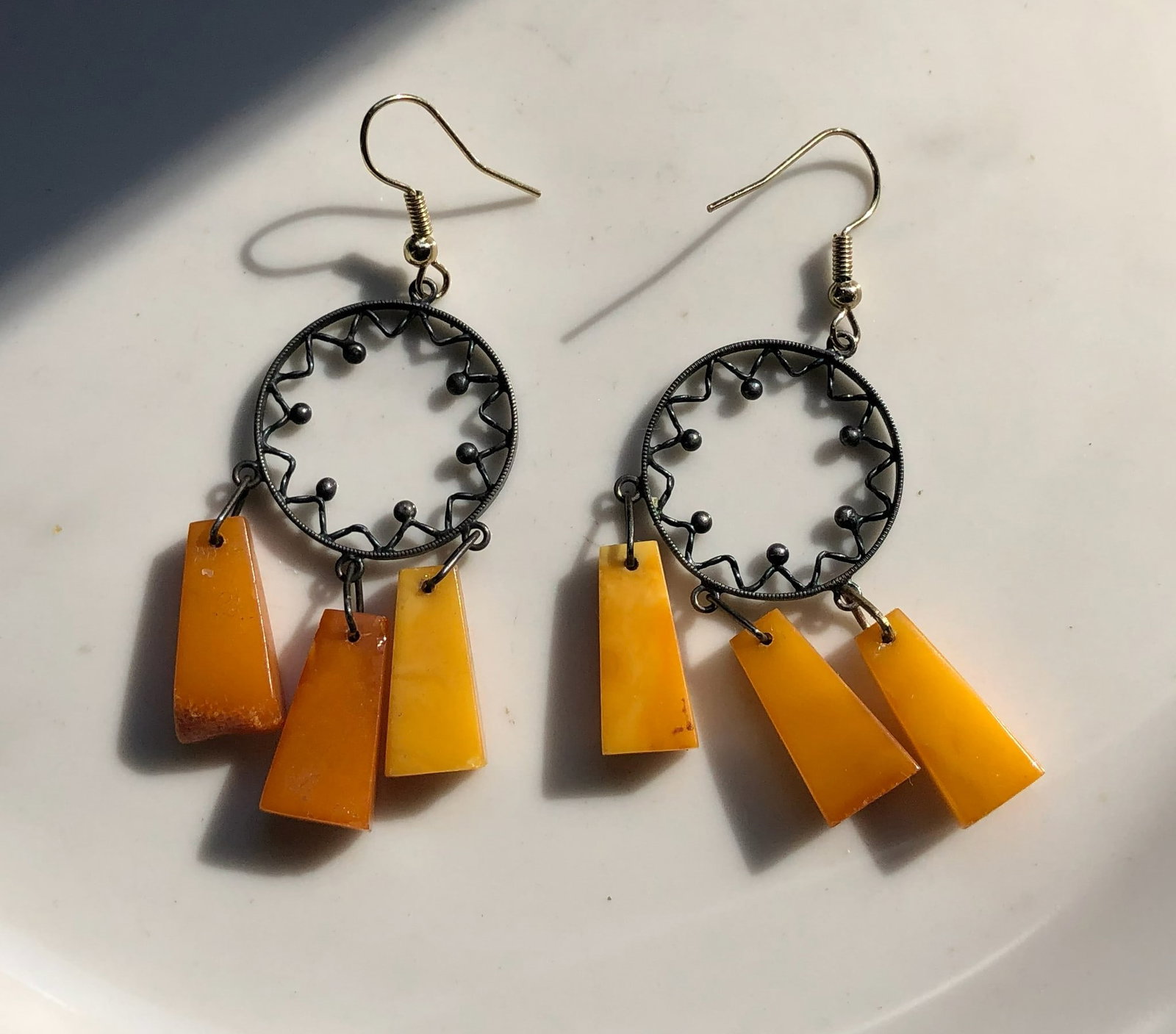 Amber Dangle Earrings: Elegant amber dangle earrings with intricate metalwork.