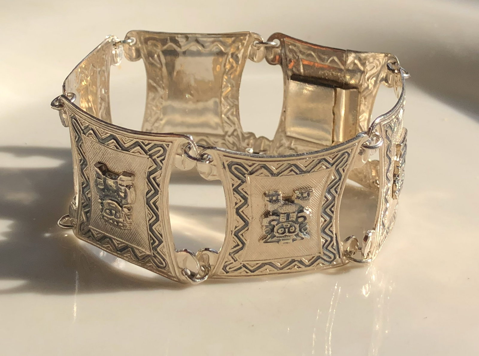 Silver Bracelet: A beautifully crafted silver bracelet with intricate designs. weight 34g.