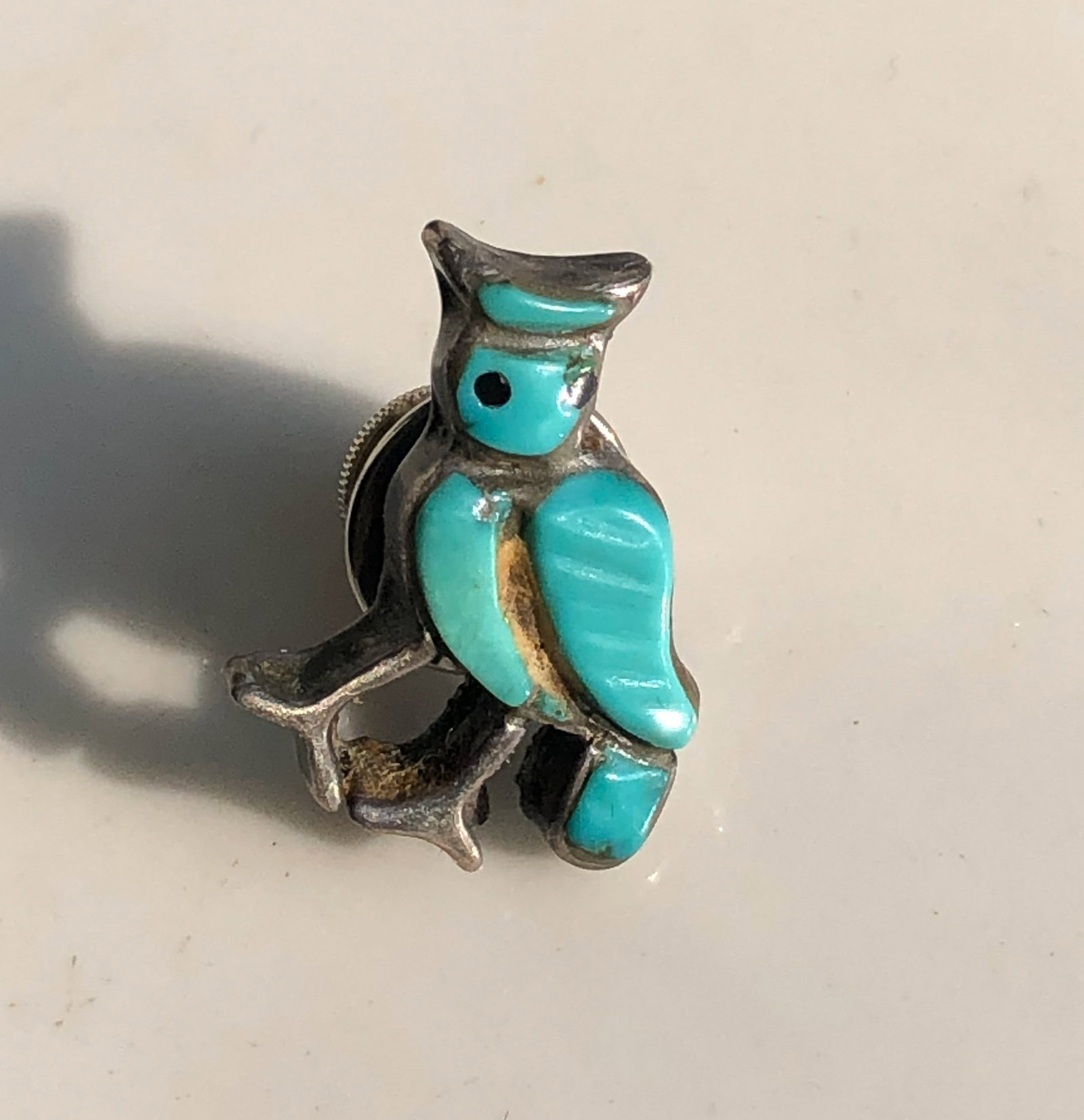Turquoise Silver Owl Pin: A charming owl-shaped silver pin with turquoise inlay, perfect for adding a touch of whimsy to any outfit.