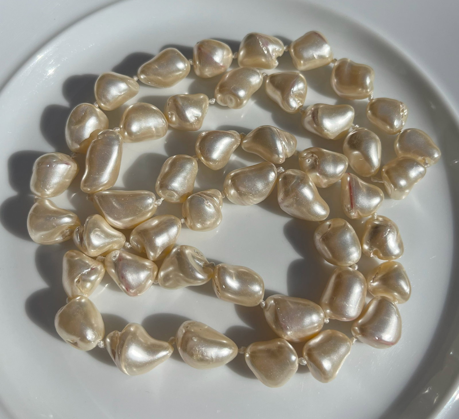Baroque Faux Pearl Necklace: A stunning baroque faux pearl necklace with unique, irregularly shaped pearls.