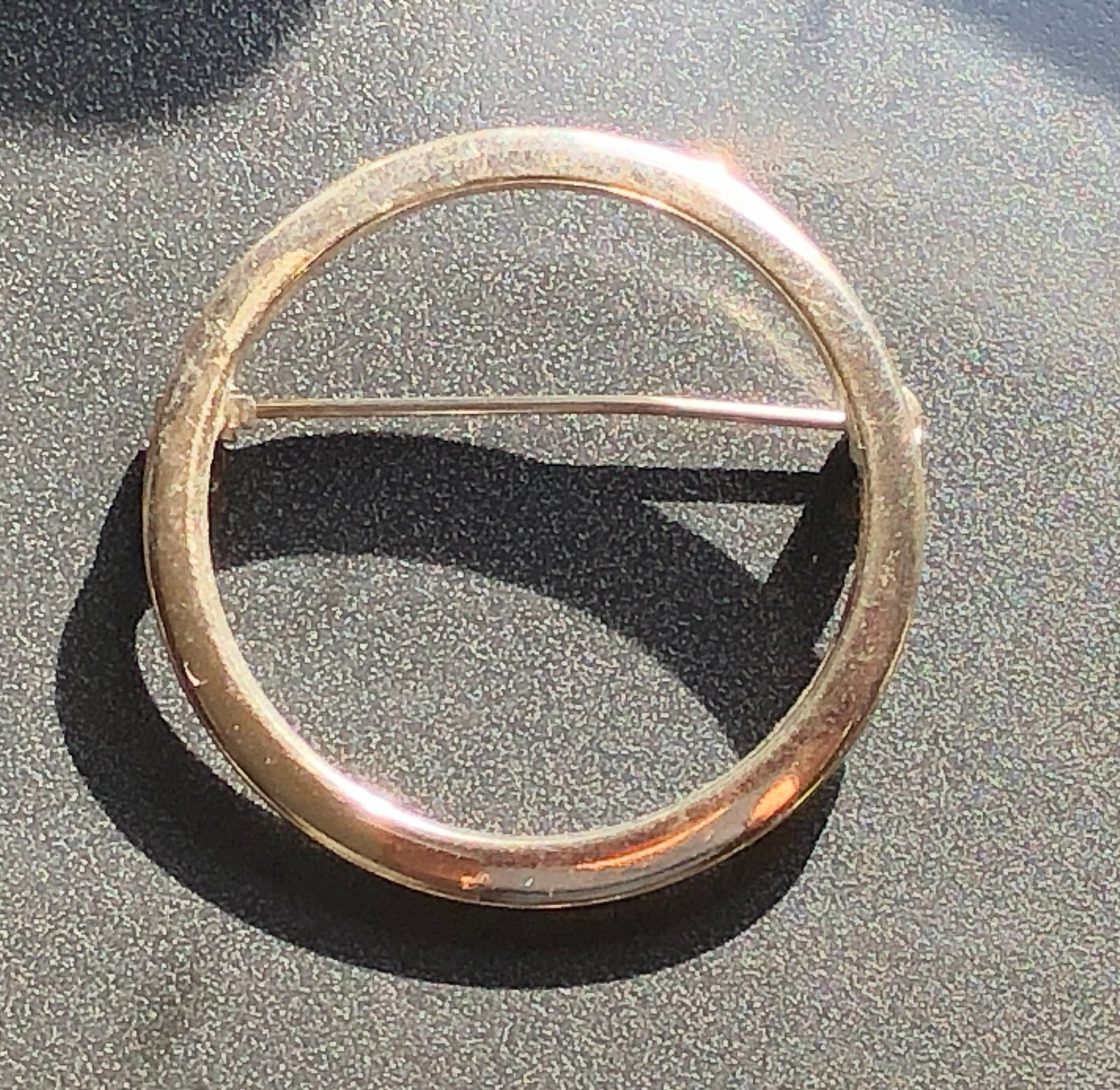 Circle Brooch: A vintage circle brooch, perfect for adding a touch of elegance to any outfit.