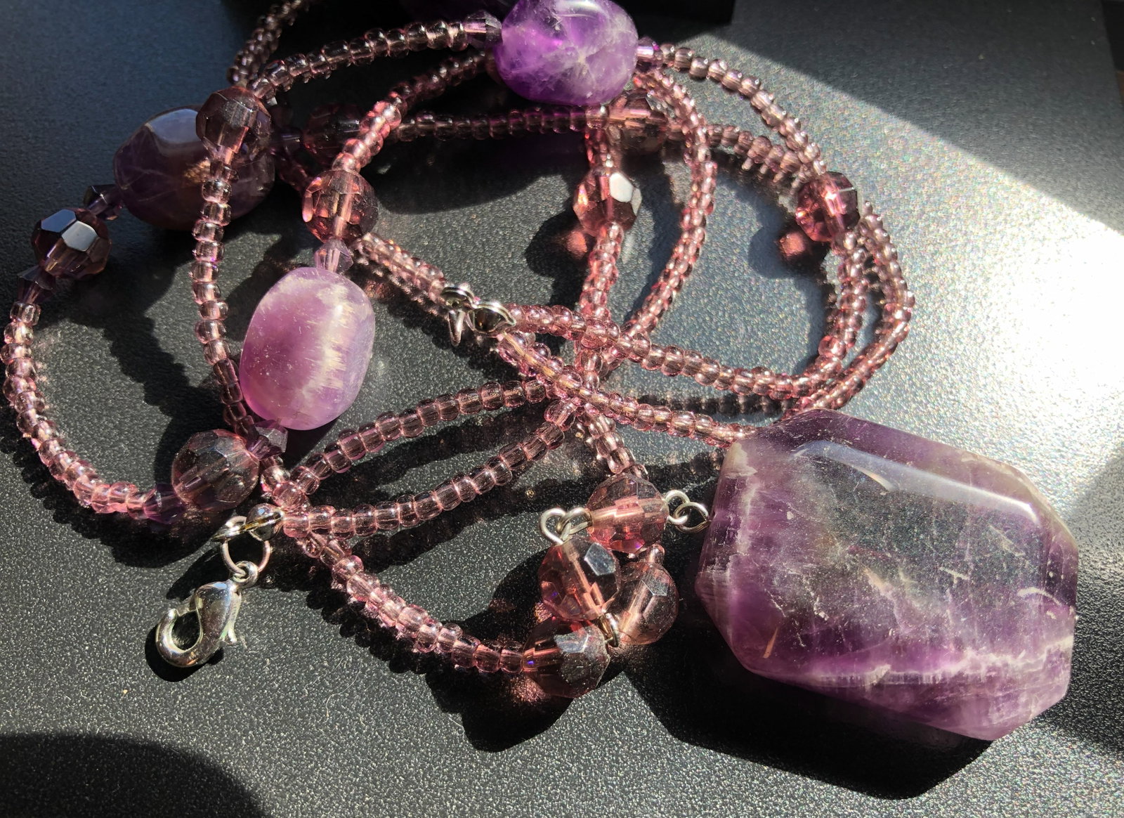 Amethyst Beaded Necklace: A beautiful amethyst beaded necklace with a lobster clasp.