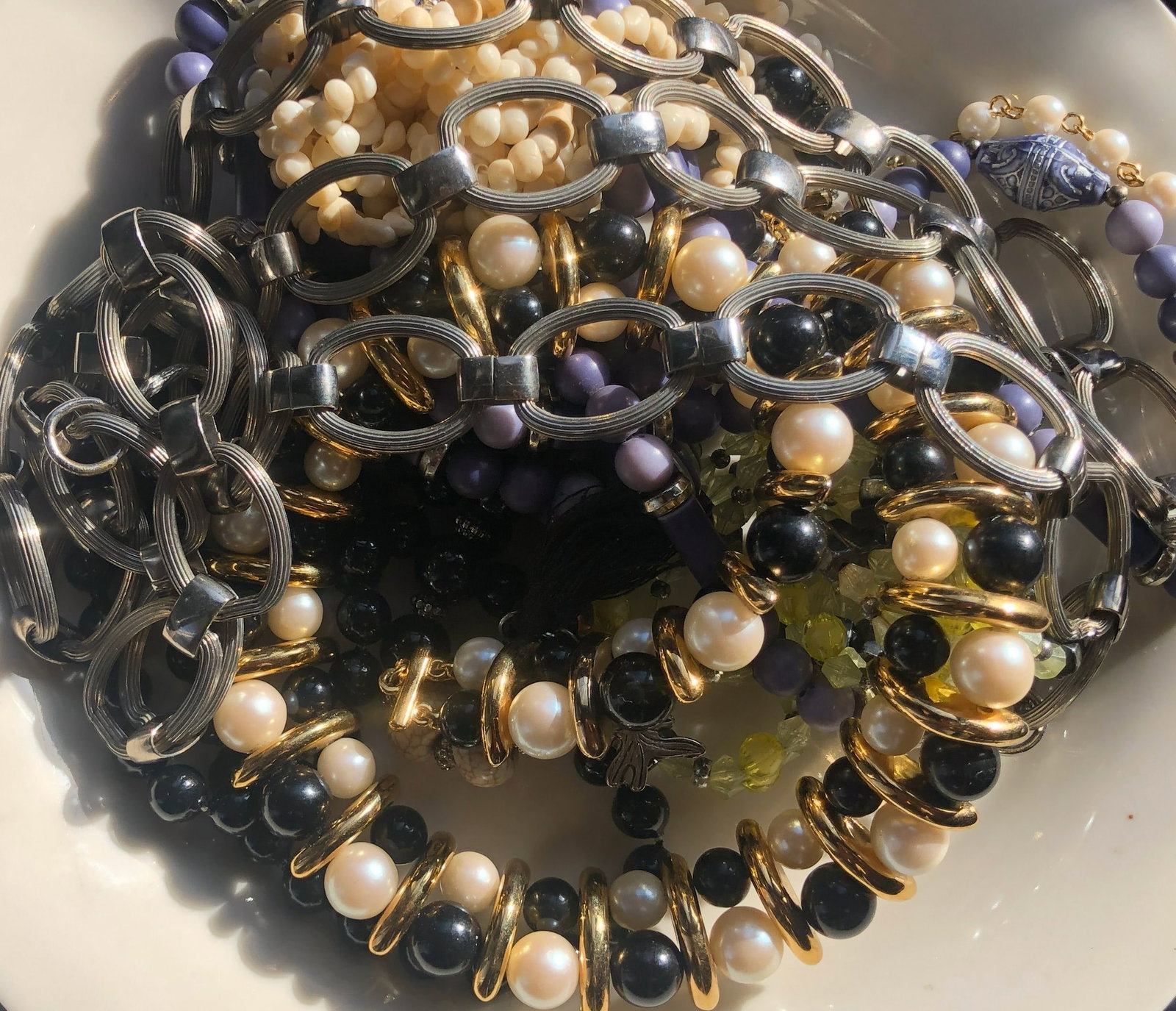Assorted Jewelry Set: A beautiful assortment of jewelry including bracelets and necklaces with pearls and beads.