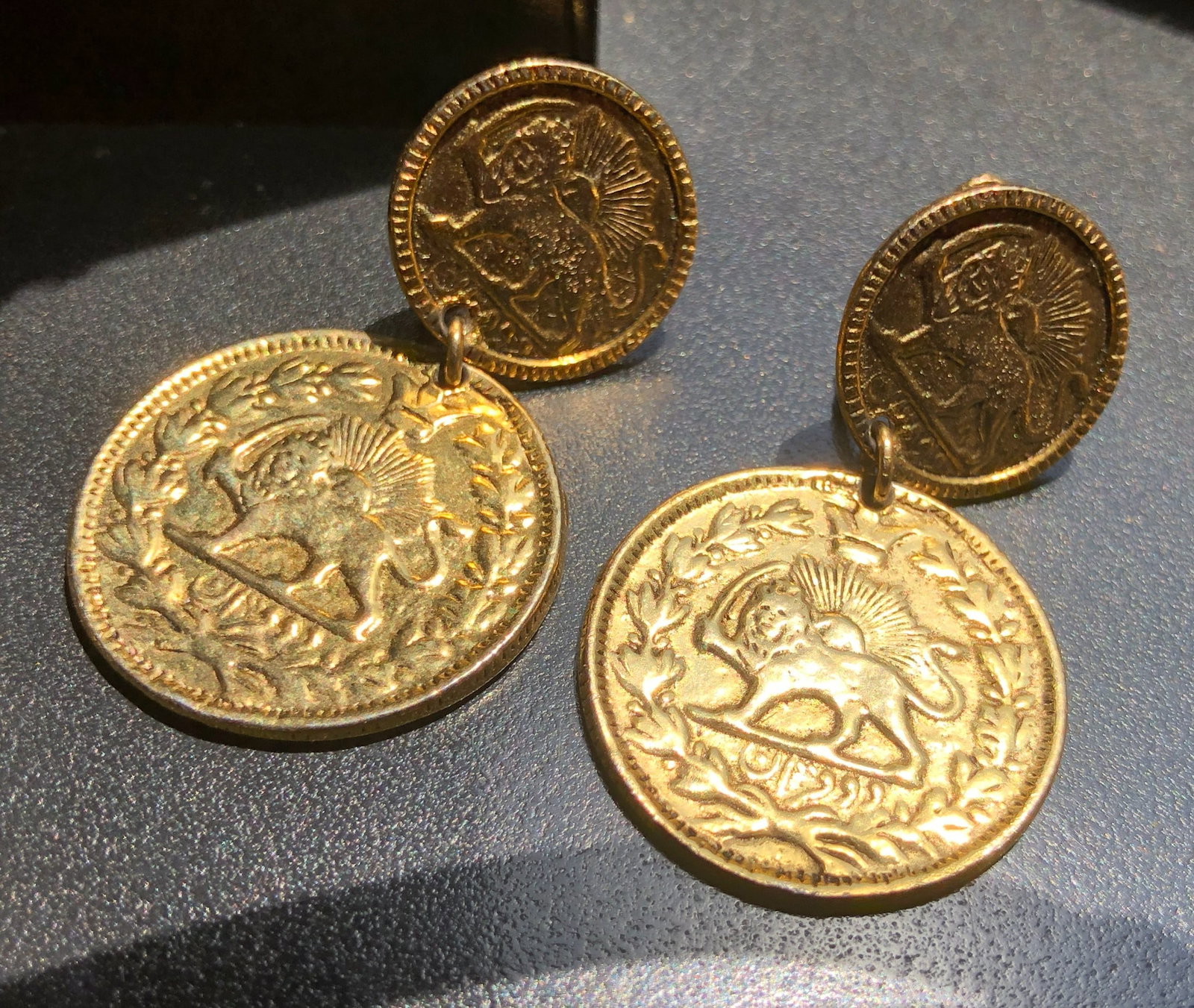 Elegant gold color coin earrings with intricate lion design: Elegant gold color coin earrings with intricate lion design