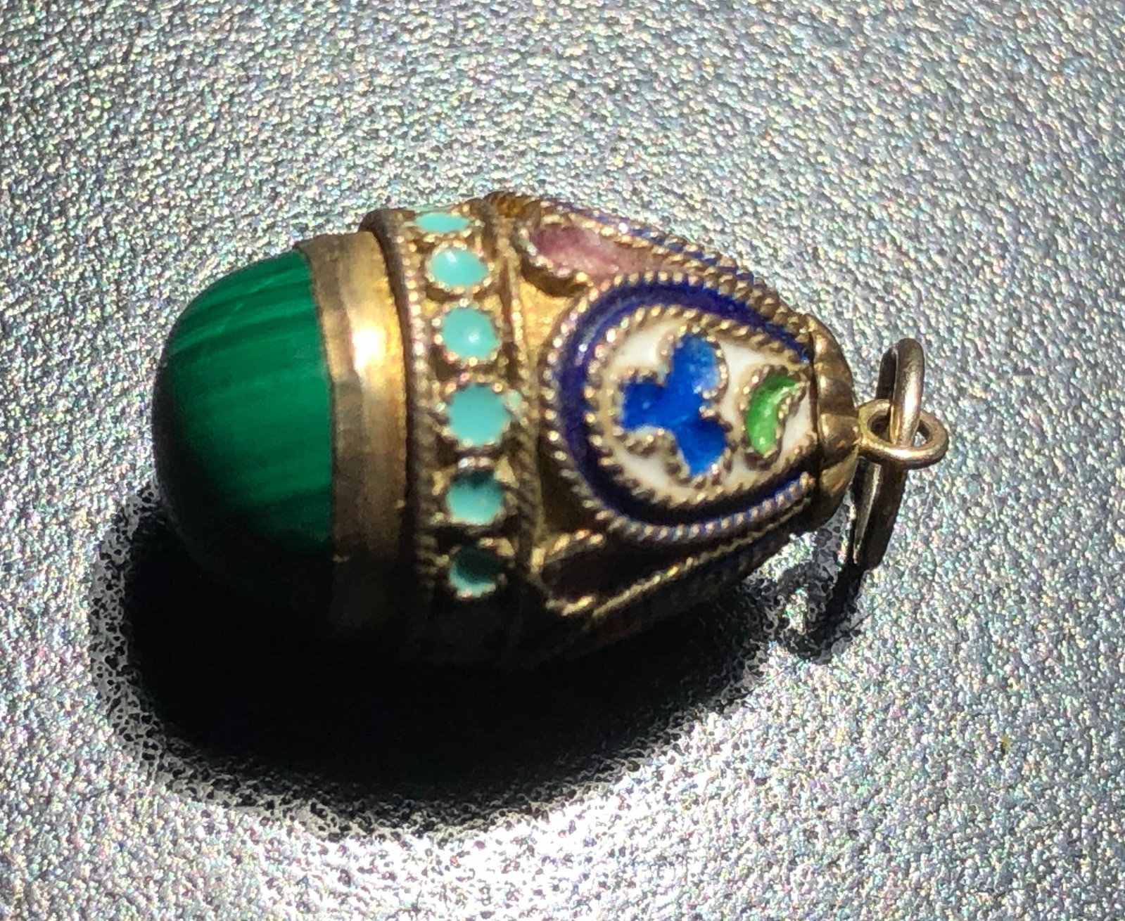 A beautifully crafted decorative silver pendant with intricate designs and vibrant colors (1 of 4)