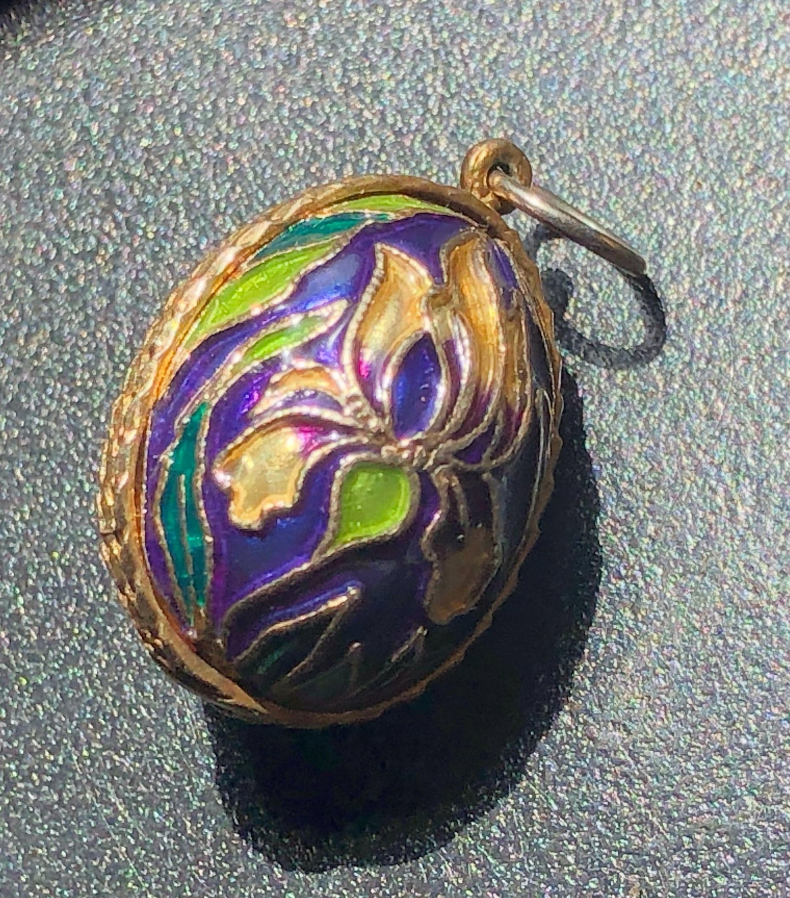 A beautifully crafted silver enamel pendant with intricate floral designs in vibrant colors: A beautifully crafted silver enamel pendant with intricate floral designs in vibrant colors