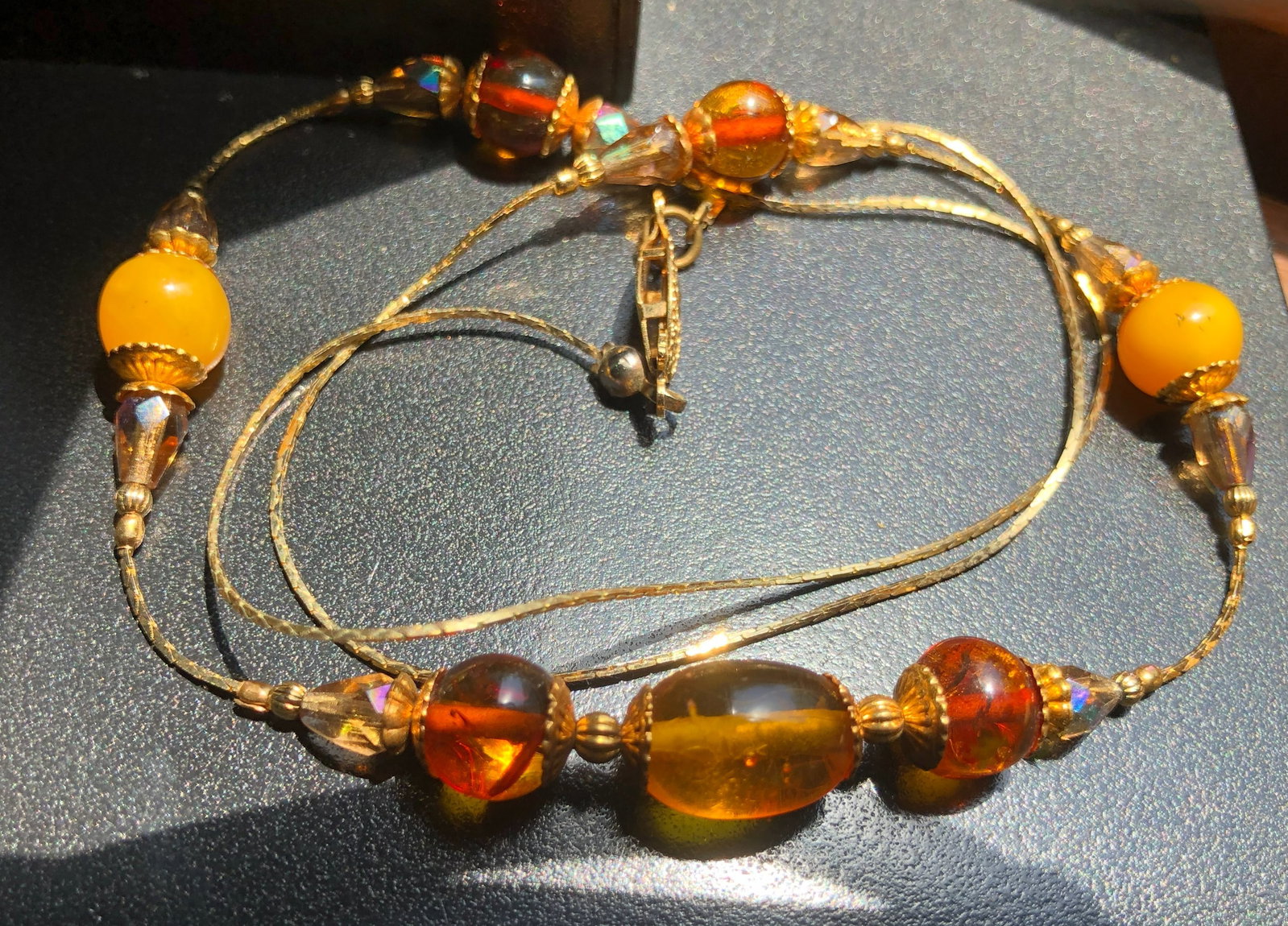 A beautiful amber color beaded necklace with intricate detailing: A beautiful amber color beaded necklace with intricate detailing