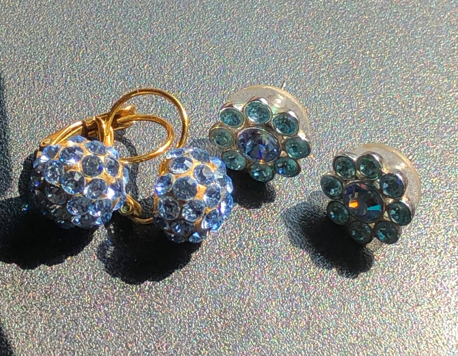A beautiful set of crystal earrings featuring a pair of hoop earrings and stud earrings, both: A beautiful set of crystal earrings featuring a pair of hoop earrings and stud earrings, both adorned with sparkling crystals