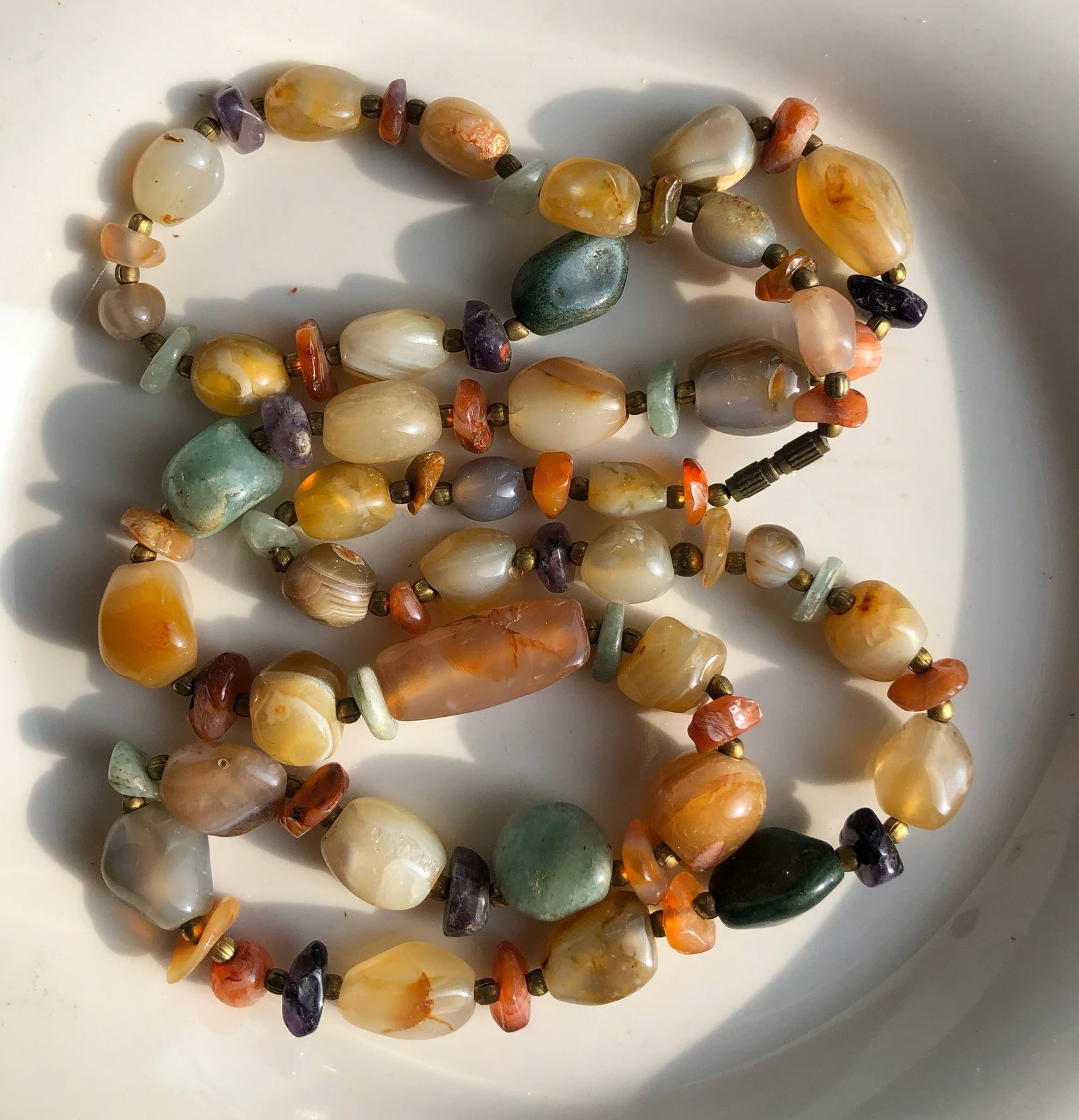 Gemstone Necklace: A beautiful handcrafted gemstone necklace featuring a variety of colorful stones.