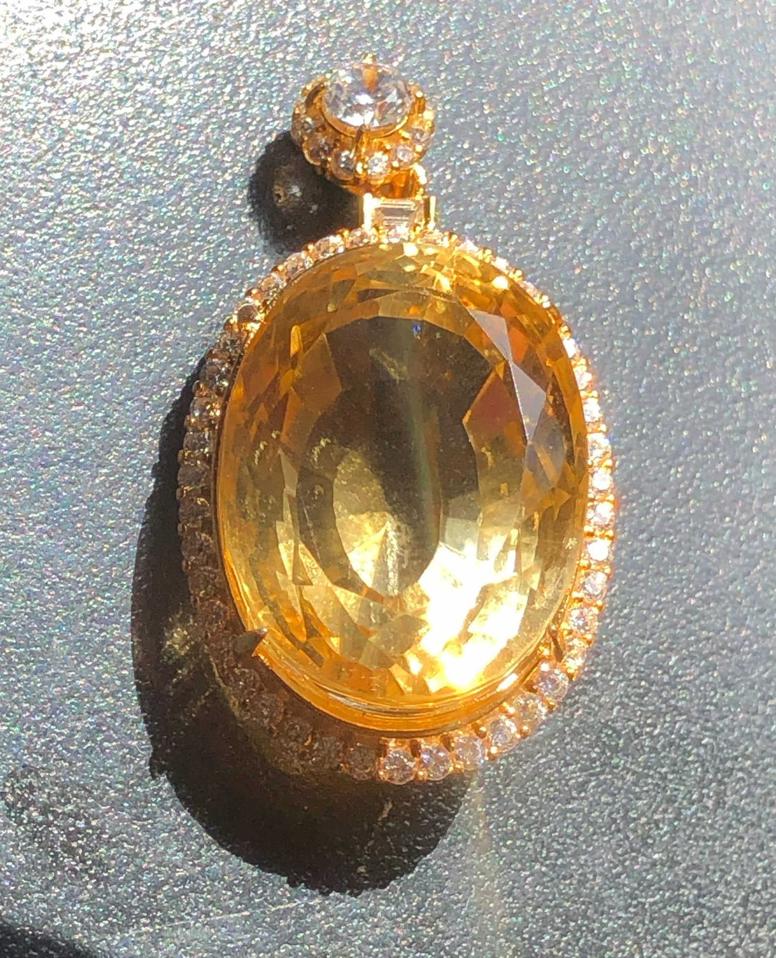 Gold Filled Citrine Pendant: A stunning gold filled pendant featuring a large central citrine surrounded by fake diamonds. Size: 1.5" x 0.75"