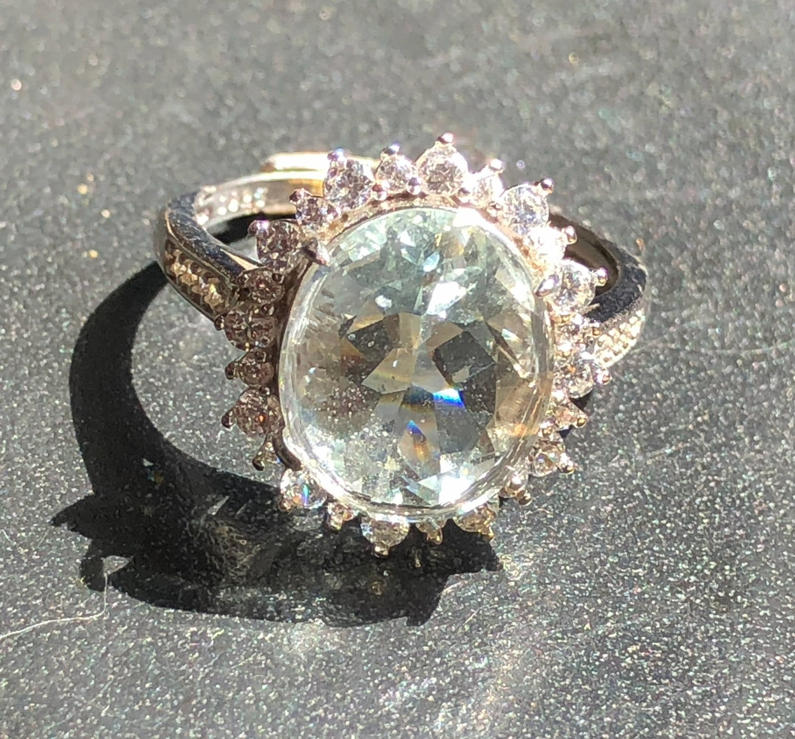 Elegant Silver Aquamarine Ring: A stunning aquamarine ring with a brilliant central stone surrounded by smaller diamonds, set in a beautifully crafted band. Size 7.