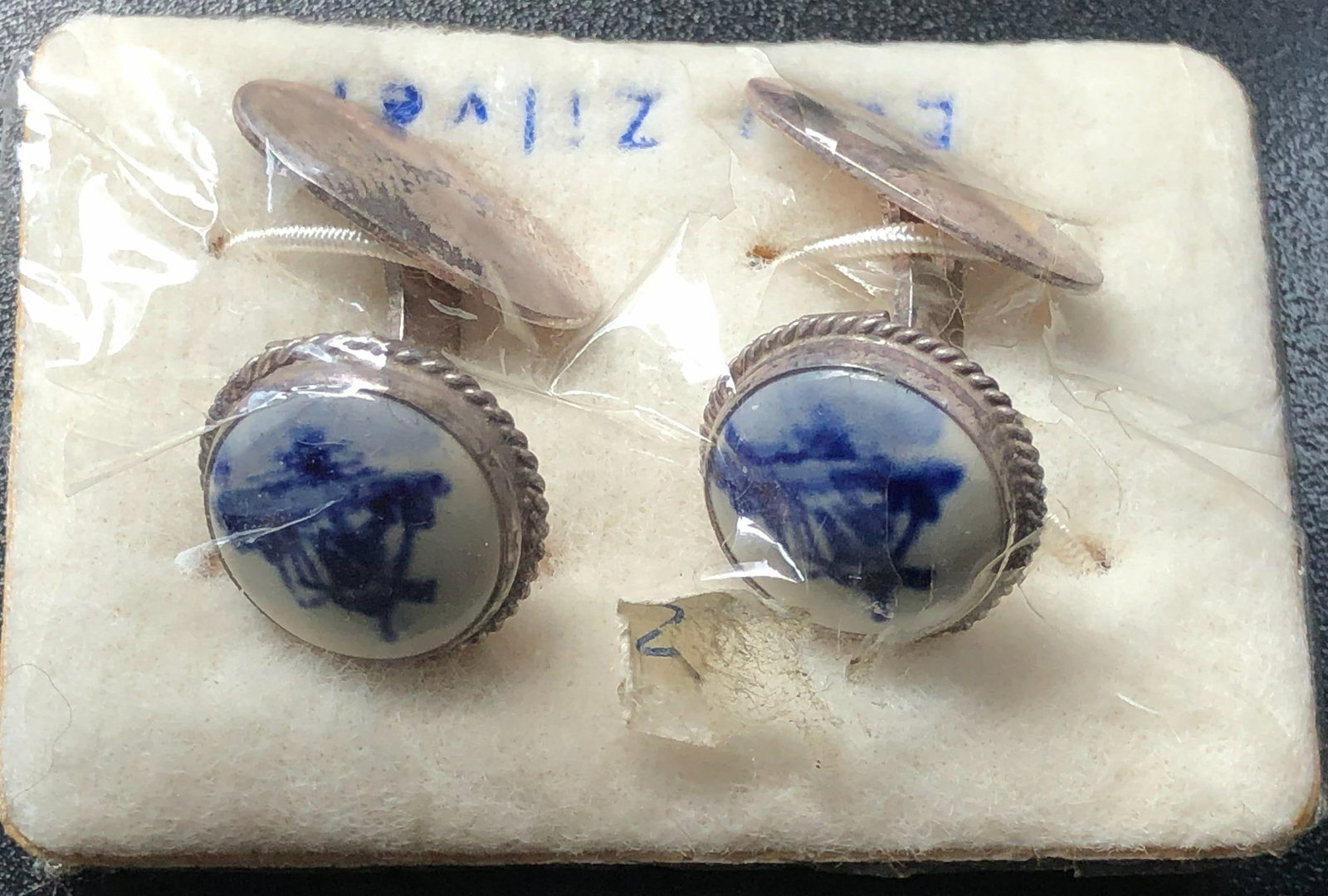 Vintage Silver Cufflinks: A pair of vintage silver cufflinks with blue and white design.