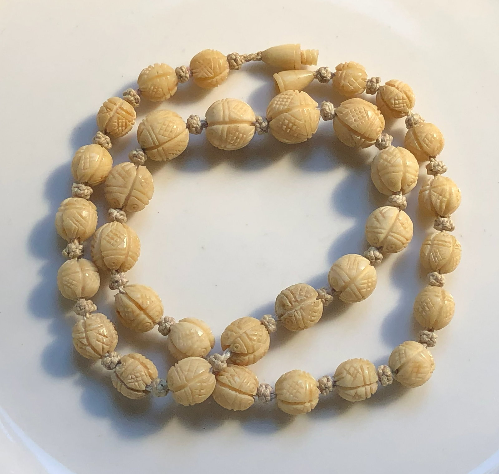 Carved Bead Necklace: A beautifully crafted necklace with intricately carved beads.