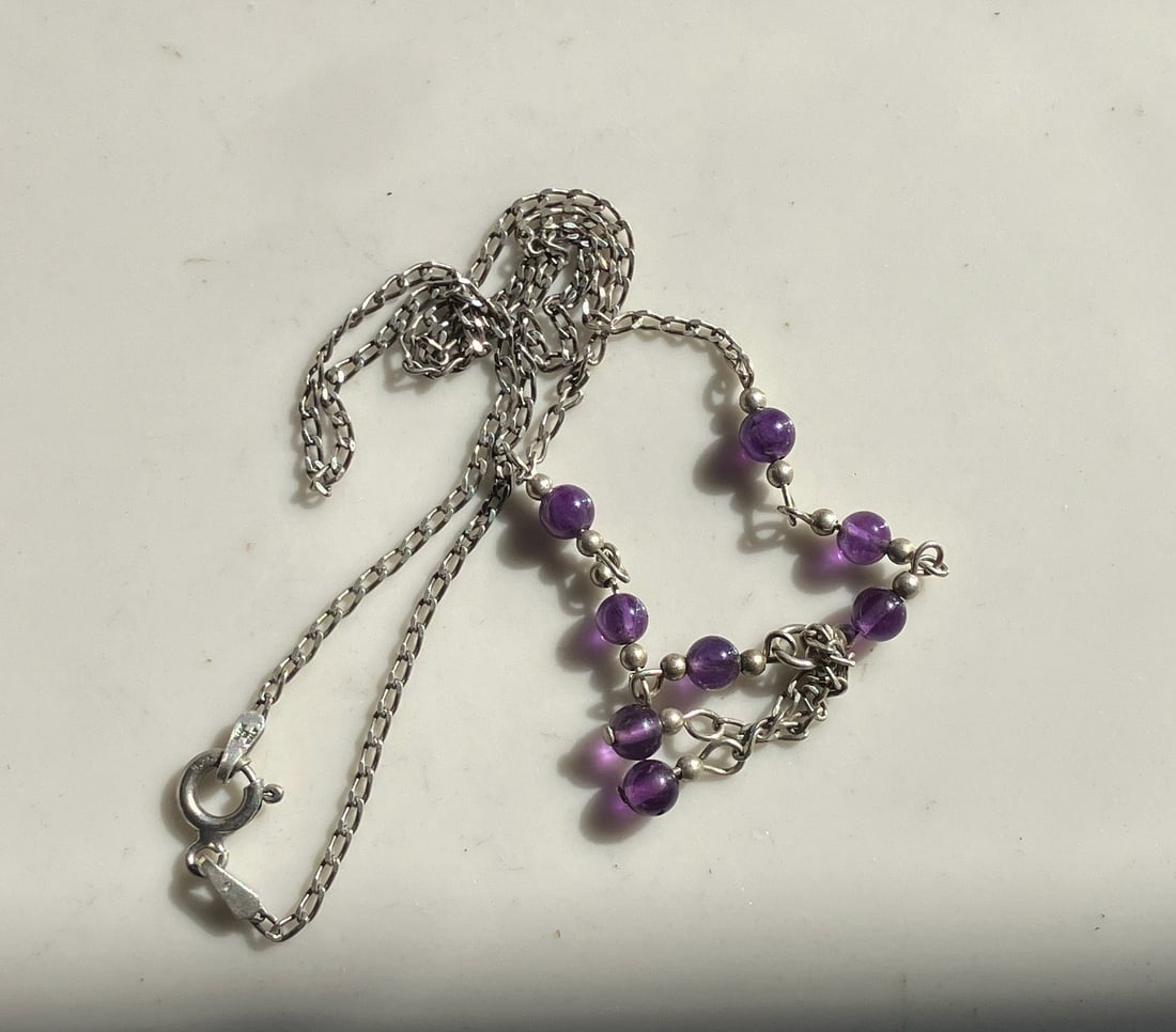 Amethyst Bead Silver Necklace: A beautiful necklace featuring amethyst beads and a silver chain.