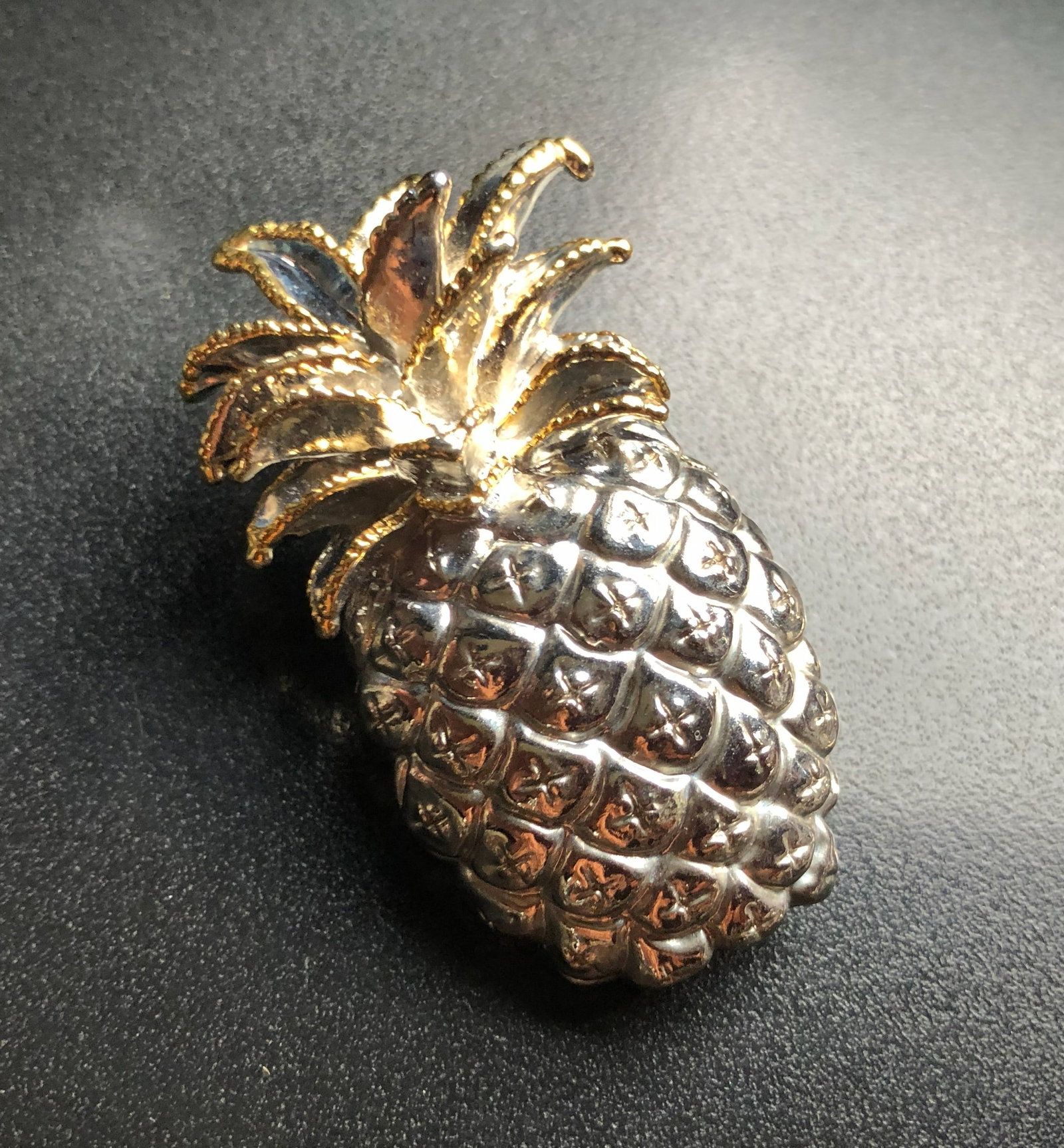Pineapple Brooch: A stylish pineapple-shaped brooch with gold and silver tones.
