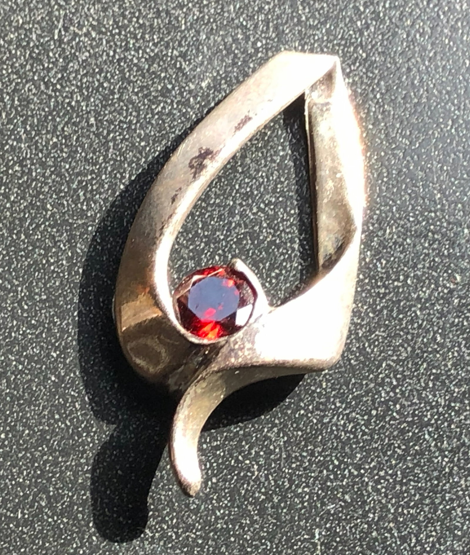 Silver Leaf Pendant with Red Gem: A beautifully crafted silver leaf pendant featuring a striking red gemstone. Size: 1"